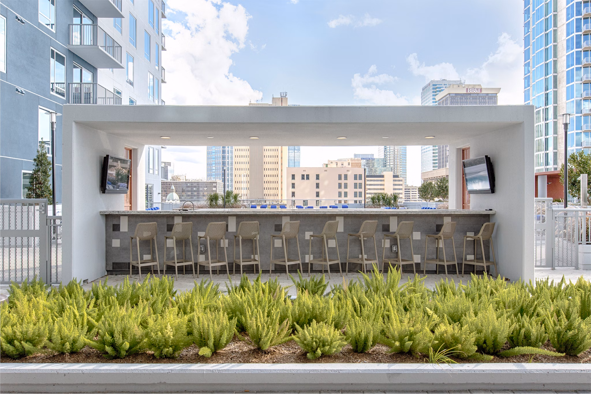 Outdoor grill area with modern seating at Nine15 Apartments
