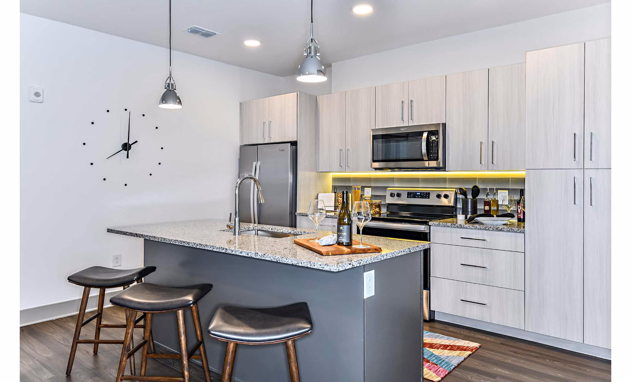 Modern kitchen with stainless steel appliances at The Jamison Apartments