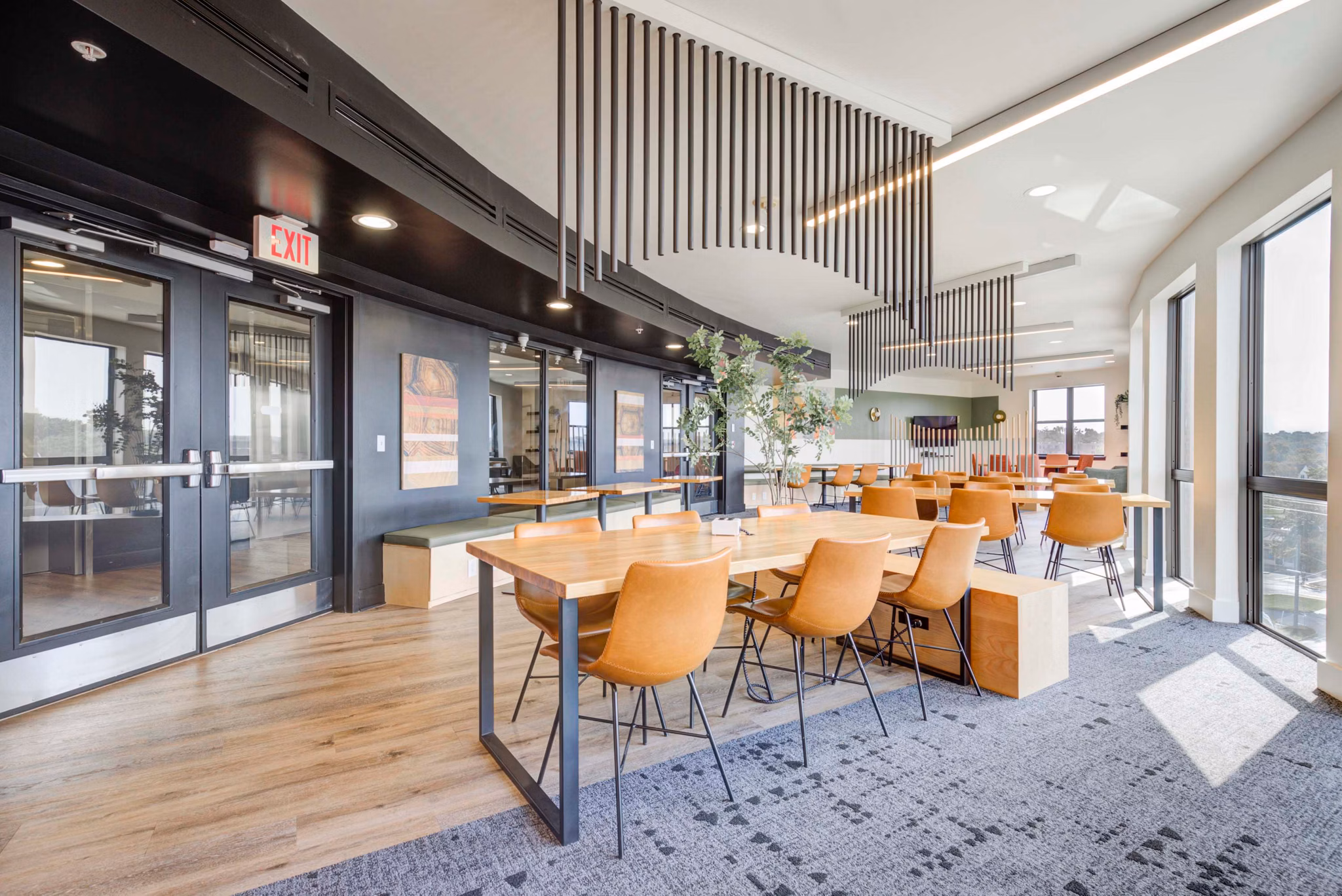 Clubhouse with modern decor and ample seating at The Varsity Apartments