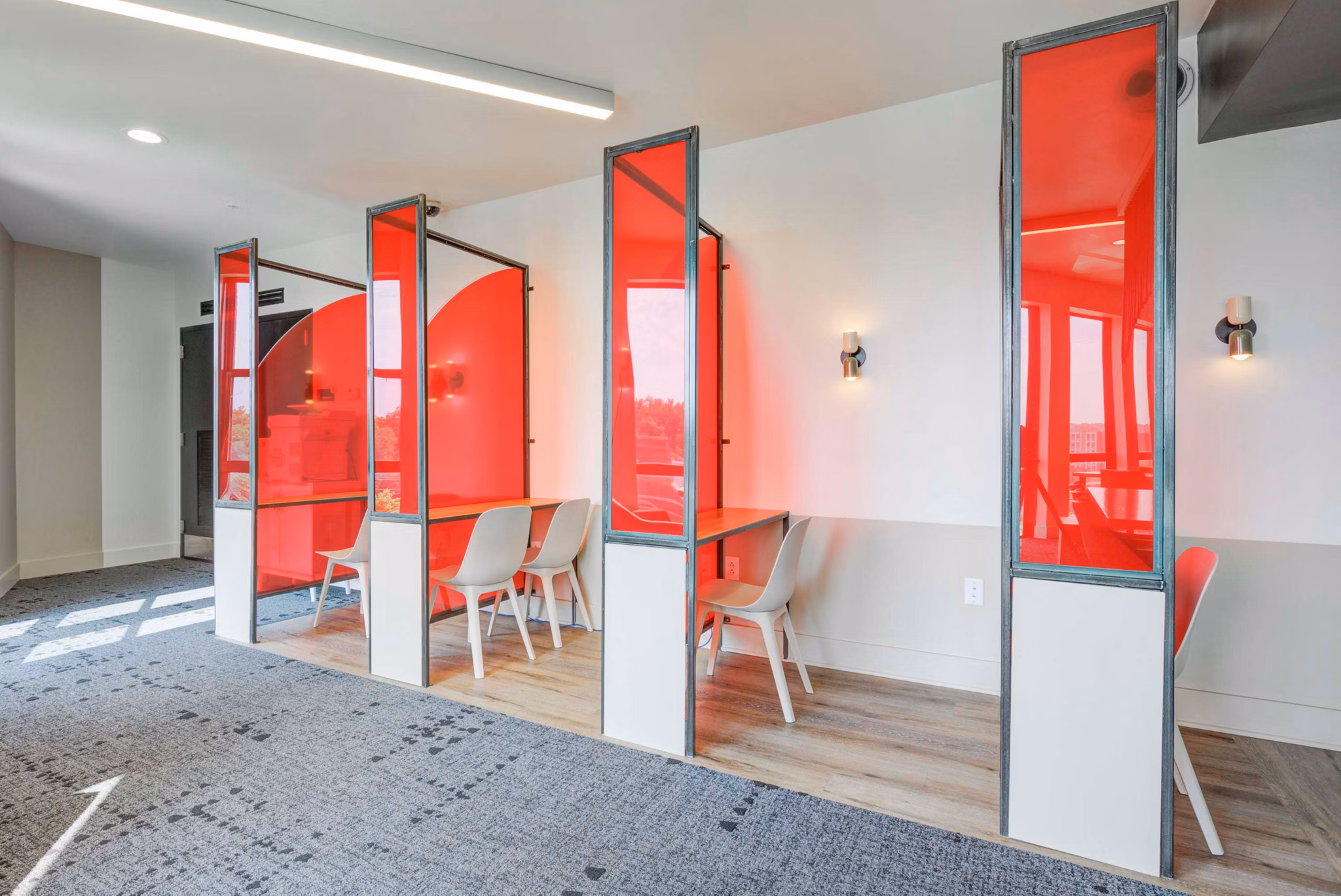 Modern clubhouse featuring lounge seating and pool tables at The Varsity Apartments