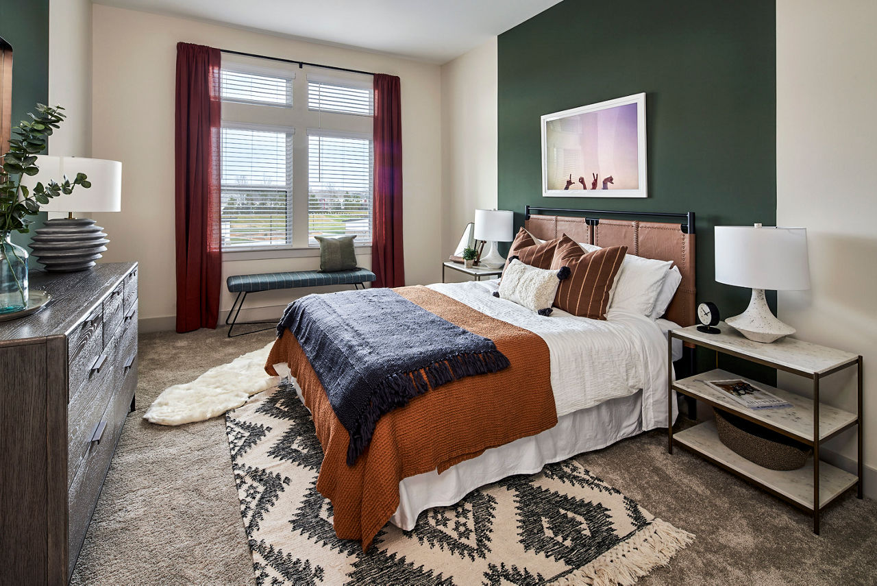 Modern bedroom with sleek design and large windows at The Court at Redstone Apartments