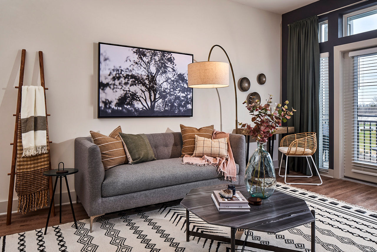 Spacious living room with modern furnishings at The Court at Redstone Apartments, offering luxury living in a Greystar community