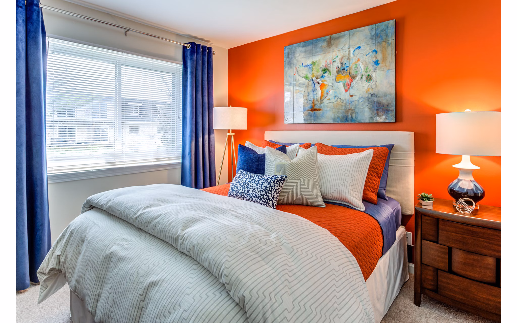 Elegant bedroom with king-sized bed at Orion Parkview Apartments, featuring plush bedding and large windows