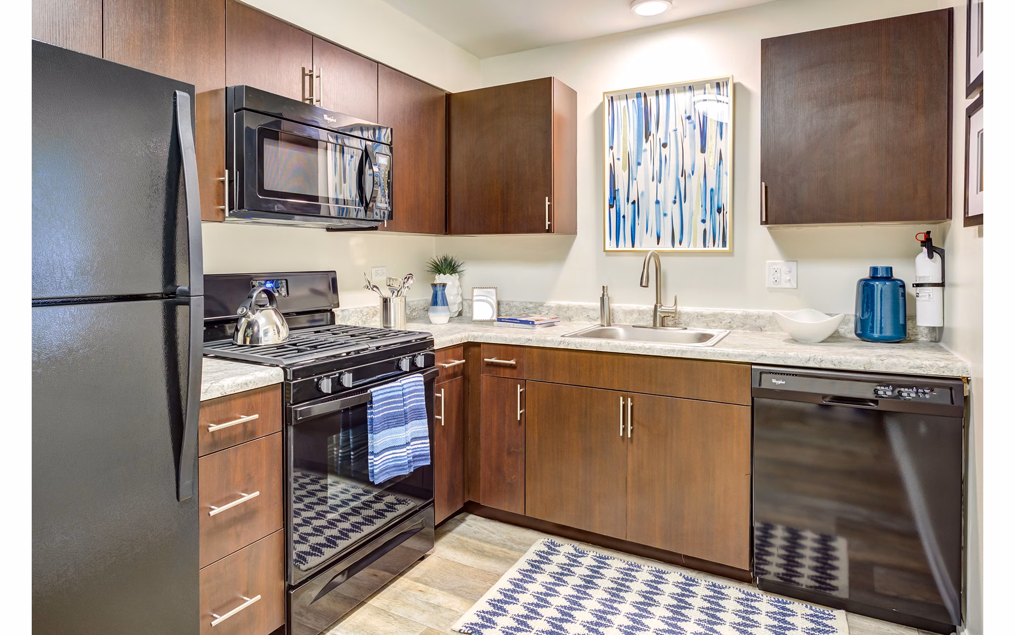 Modern kitchen with stainless steel appliances and granite counters at Orion Parkview Apartments