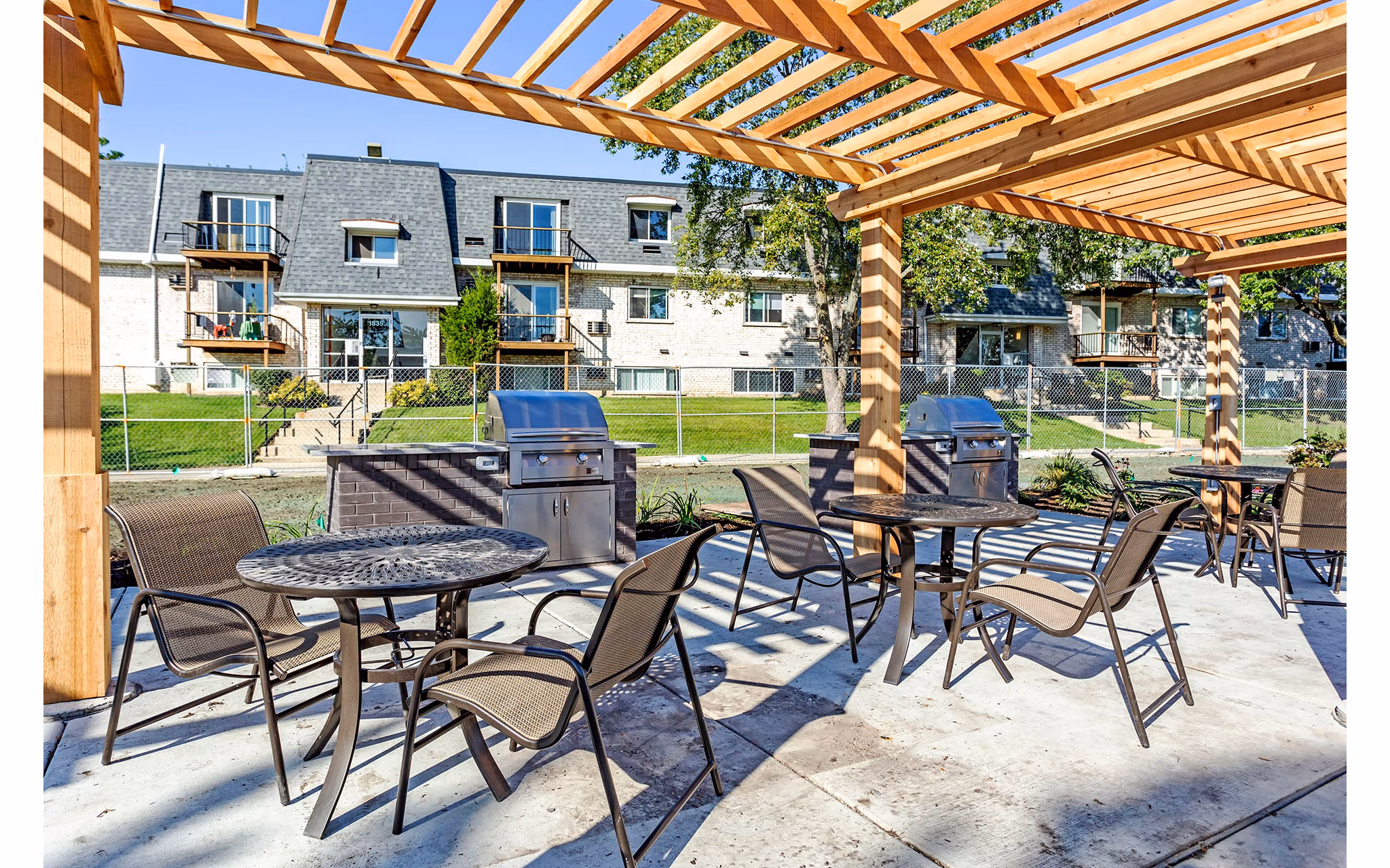 Outdoor grill area with modern seating at Orion Parkview Apartments featuring lush greenery and BBQ facilities for residents to enjoy