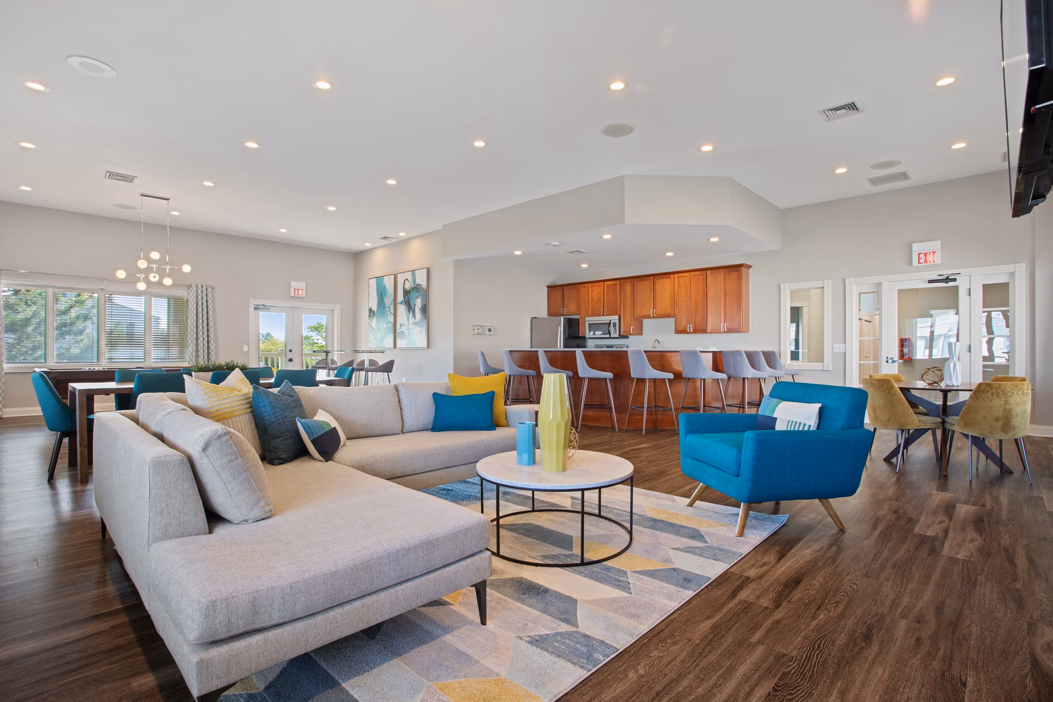 Stylish clubhouse with modern decor at Orion Prospect Apartments, featuring ample seating and a contemporary design