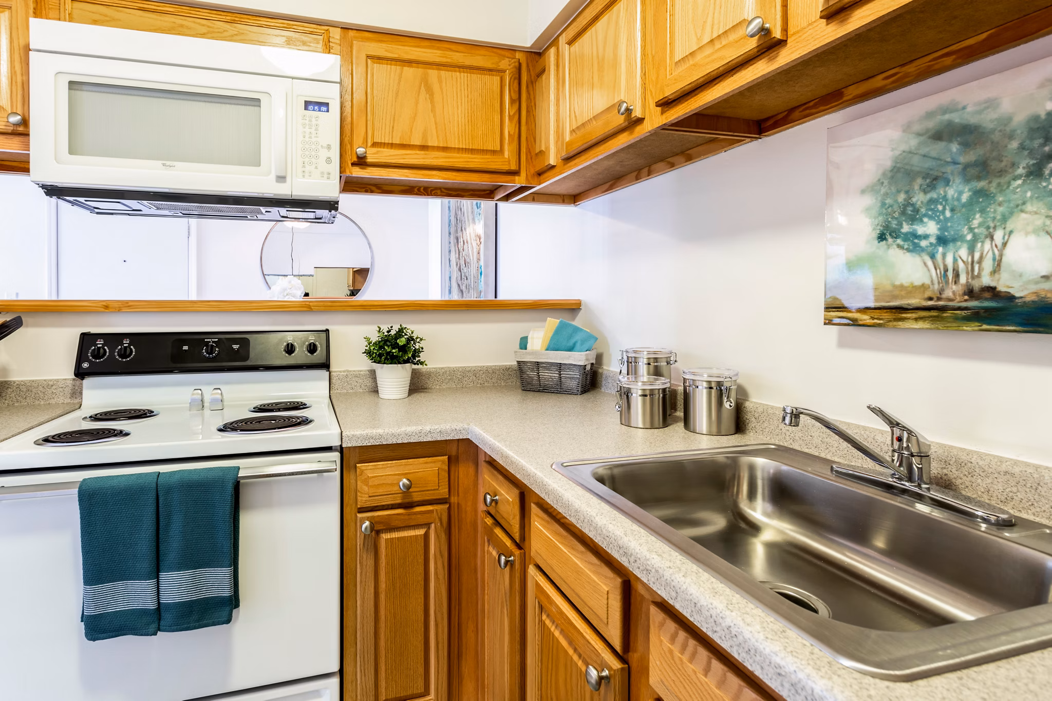 Modern kitchen with stainless steel appliances at Orion Prospect Apartments with breakfast bar