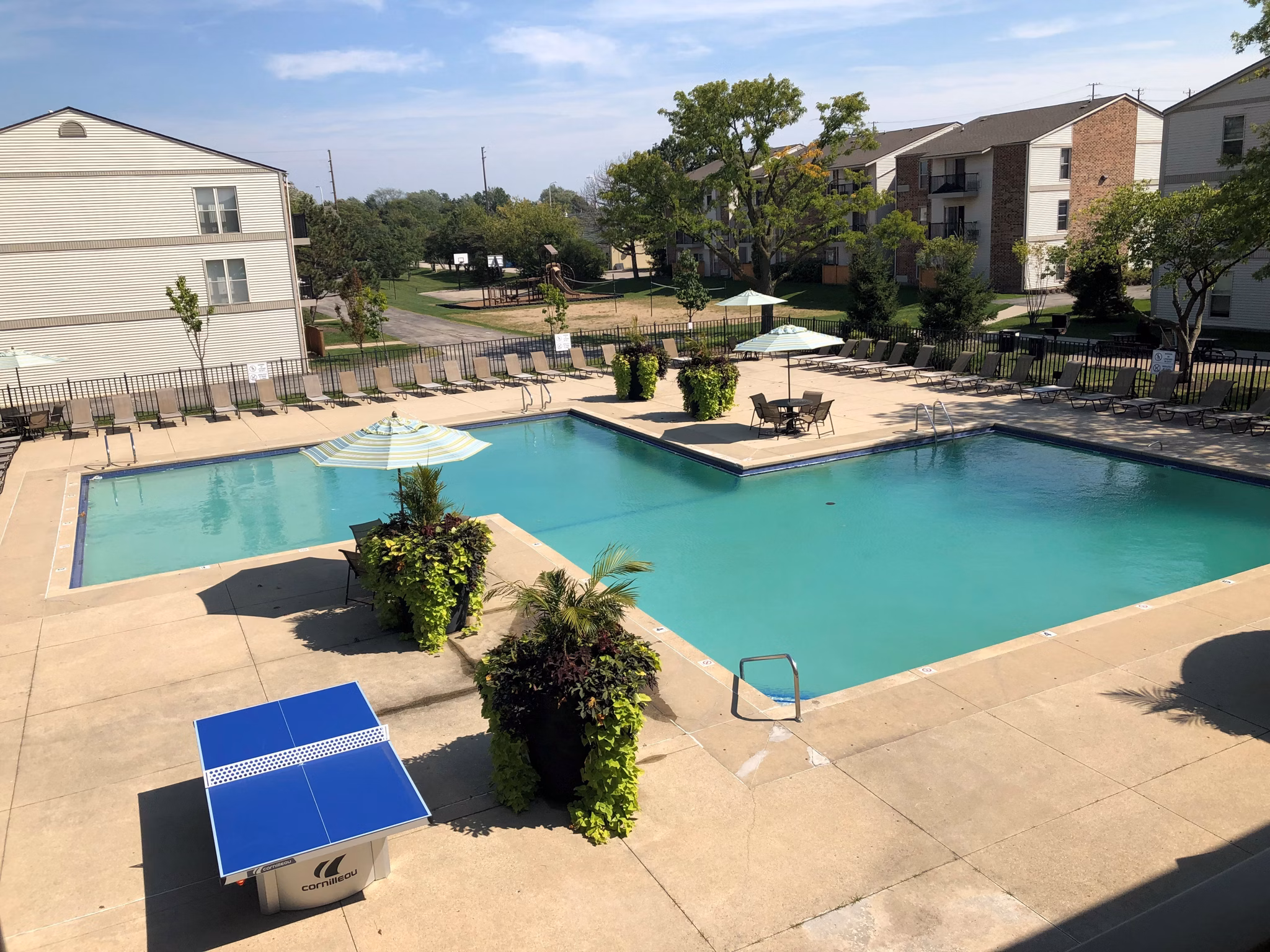 Orion Prospect Apartments: Luxurious pool area with sun loungers and landscaping - ideal for relaxation and leisure activities