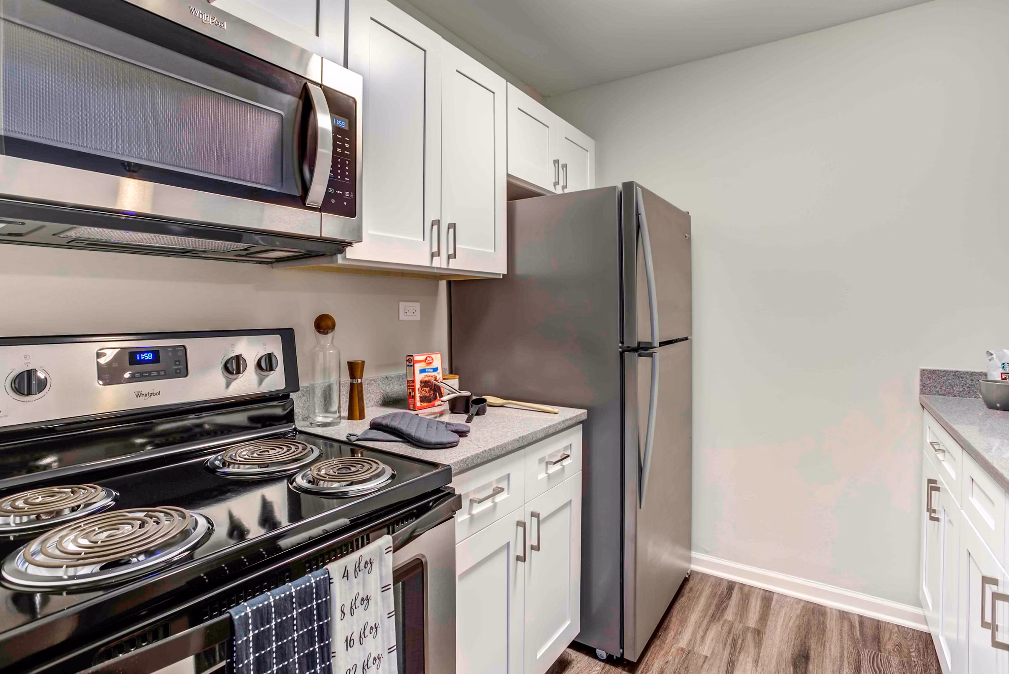 Modern kitchen with stainless steel appliances at Orion 59 Apartments