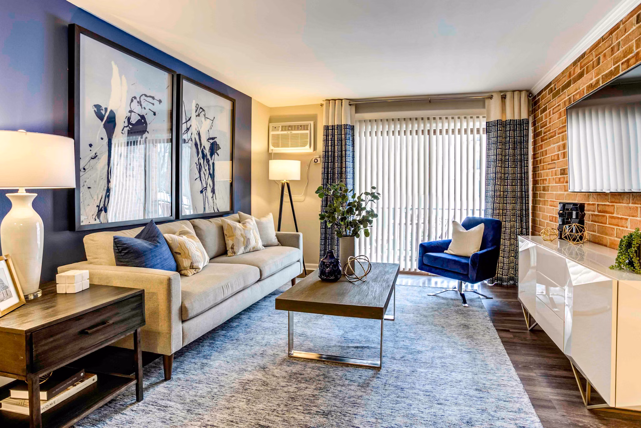 Spacious living room with modern decor and natural light in Orion 59 Apartments