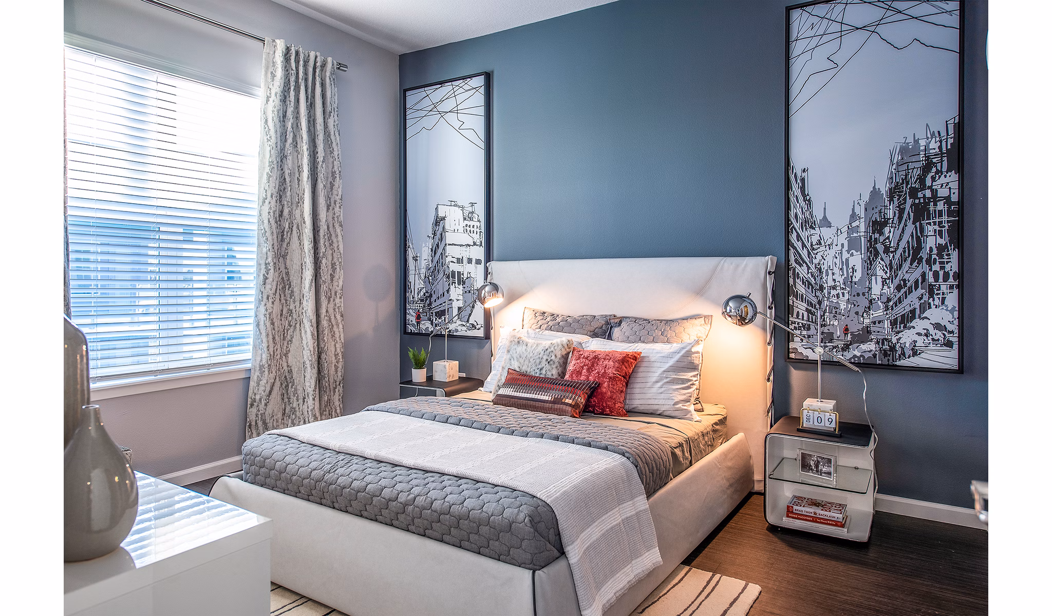 Bedroom featuring plush bedding and large windows at Sanctuary at Centerpointe Apartments