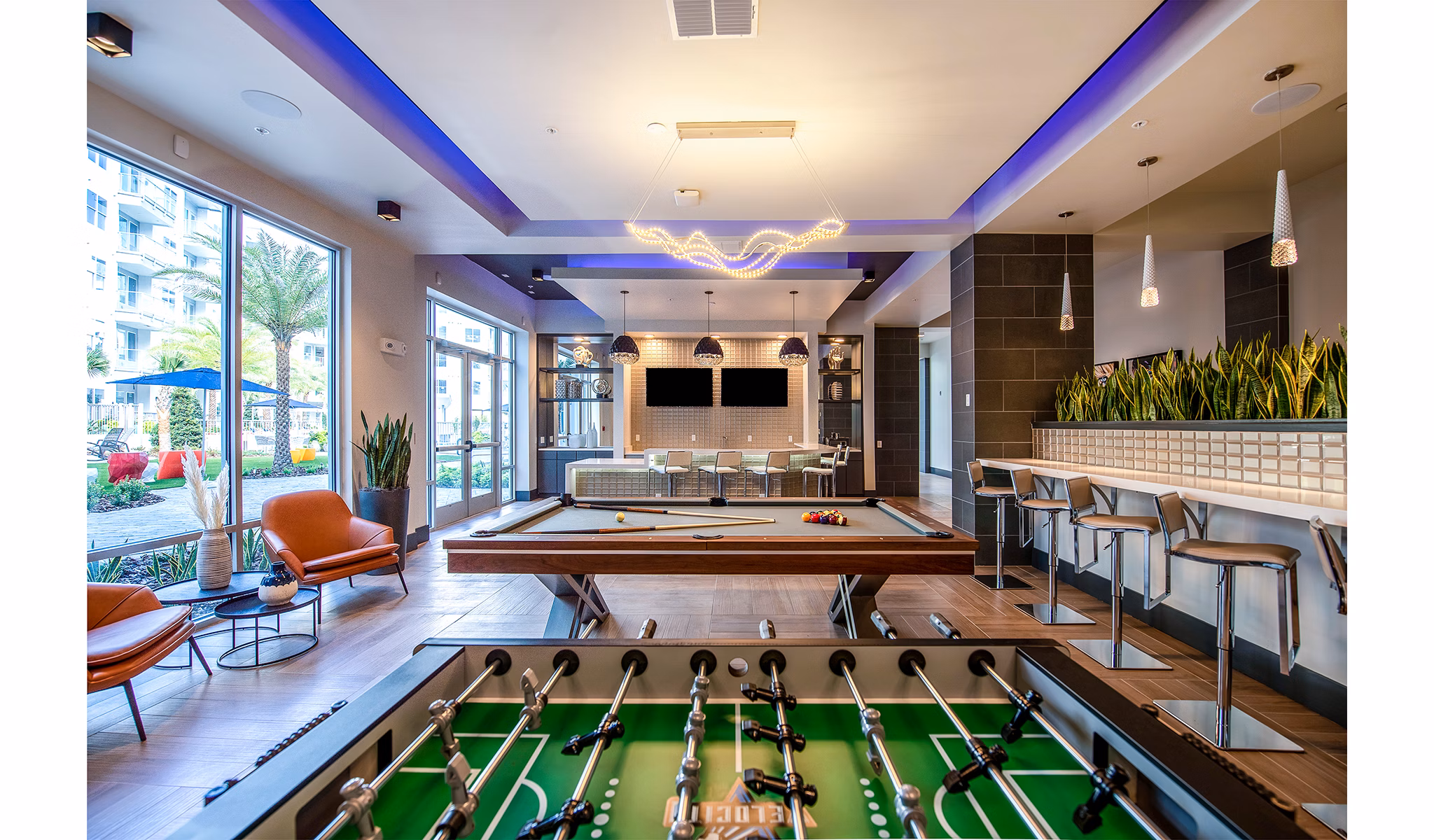 Game room offering modern entertainment options at Sanctuary at Centerpointe Apartments