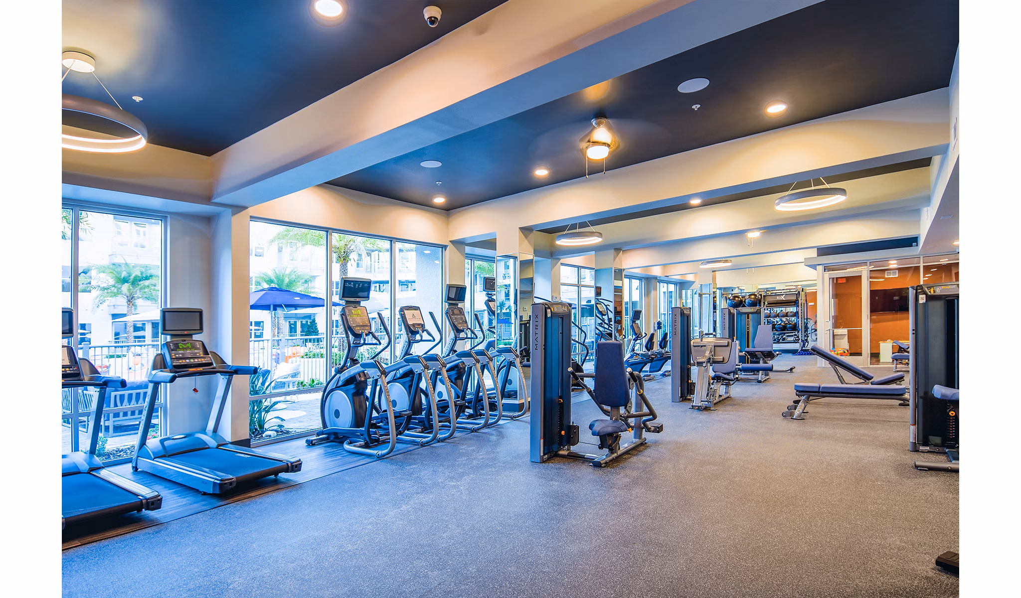 Sanctuary at Centerpointe: Modern fitness center with state-of-the-art equipment and natural lighting for residents