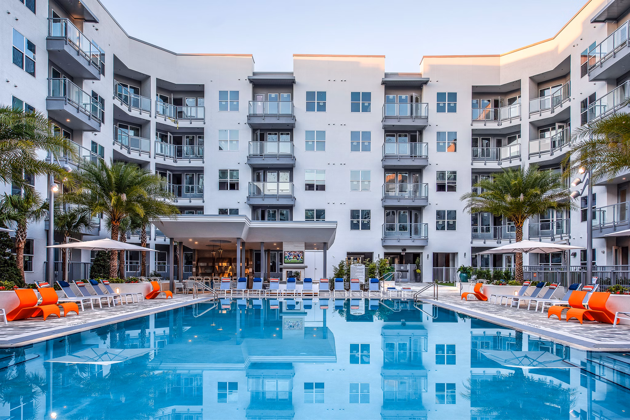 Infinity pool at Sanctuary at Centerpointe Apartments offers a tranquil escape with lush surroundings and sun lounges