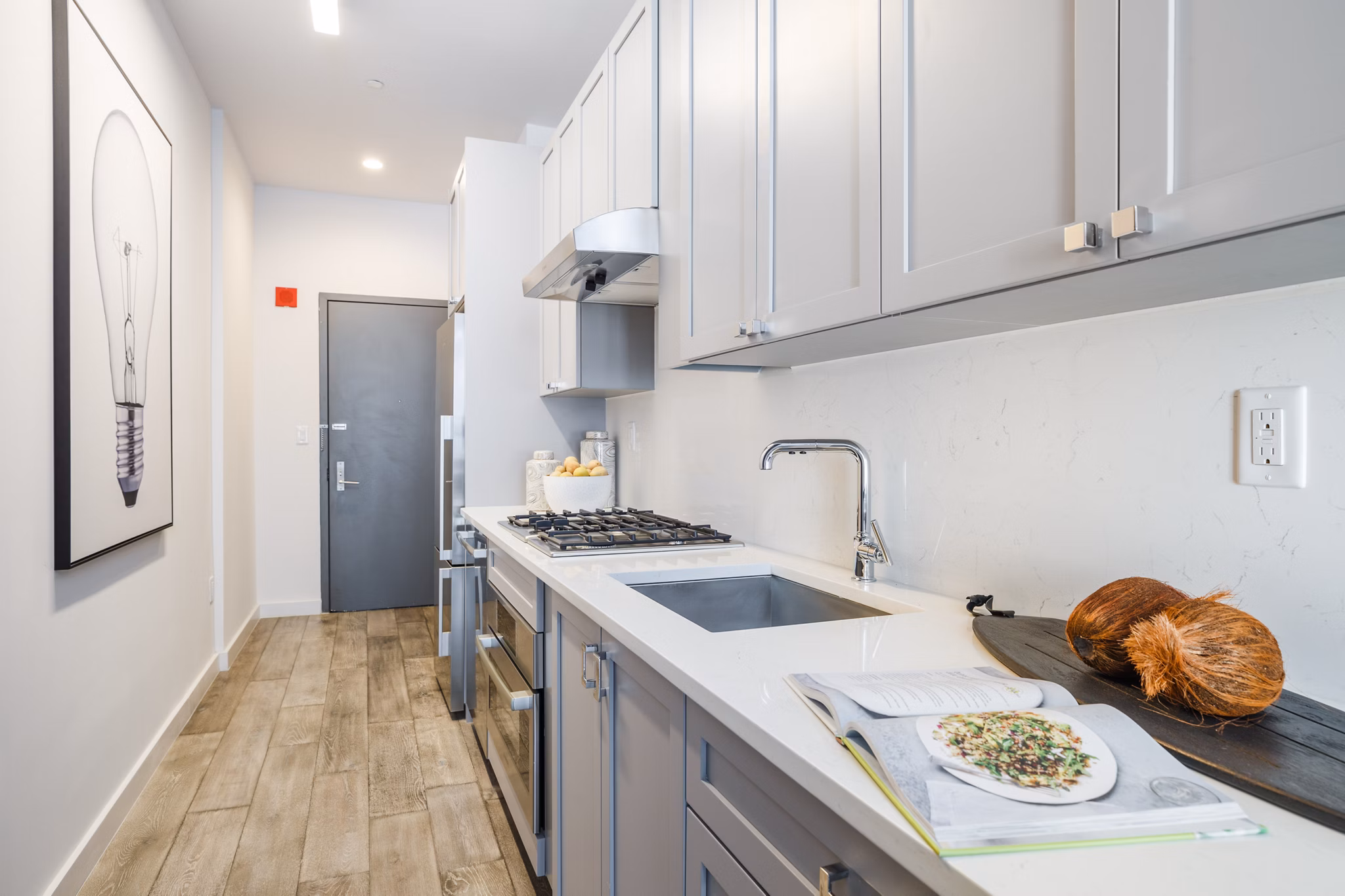 Modern kitchen with sleek countertops and stainless steel appliances in 1 Flatbush Apartments luxury community