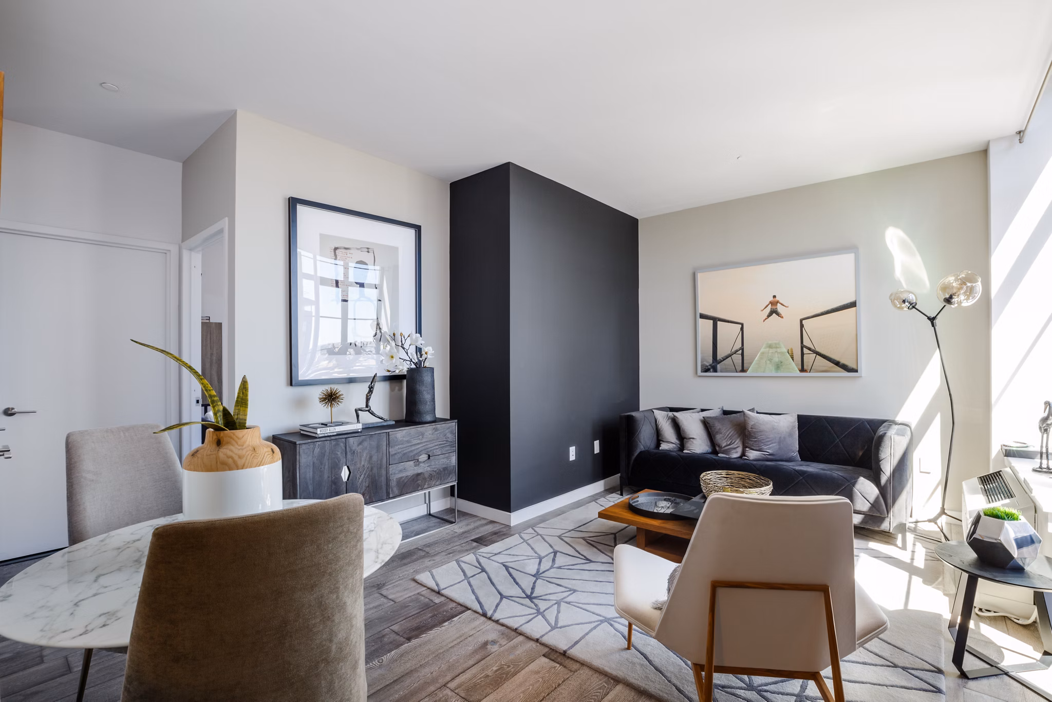 Spacious living room with modern decor and large windows in 1 Flatbush Apartments, Brooklyn