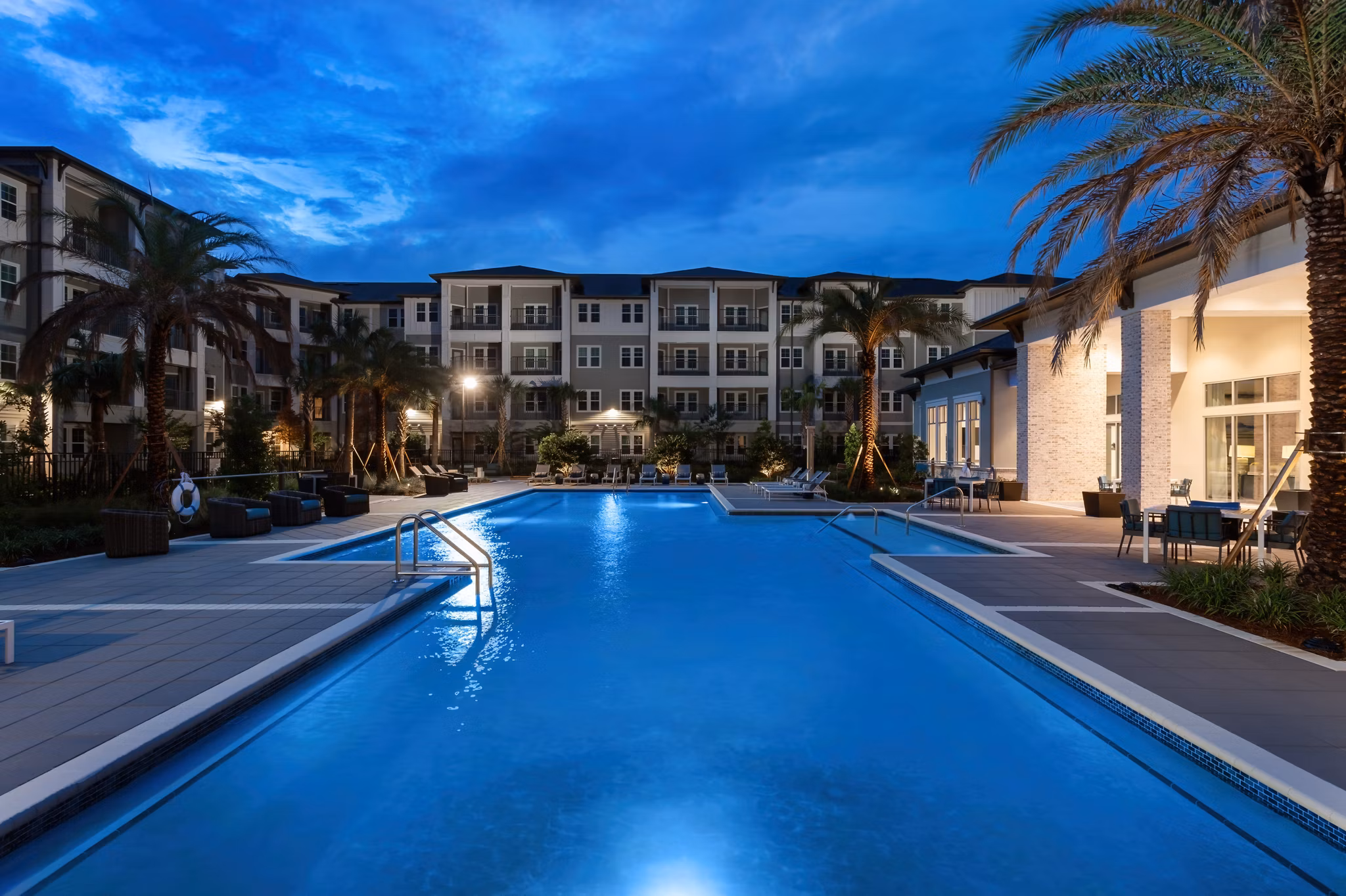 Serene outdoor pool with lounge chairs at Overture Hamlin Apartments, ideal for relaxation and leisure