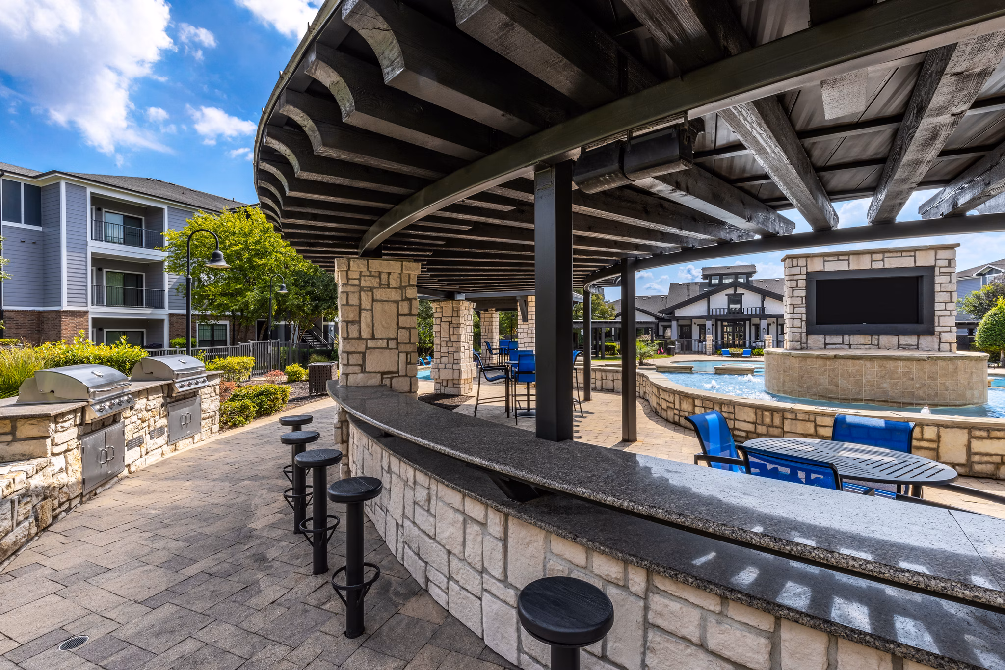 Outdoor grill area with modern appliances at The Oaks at Techridge Apartments