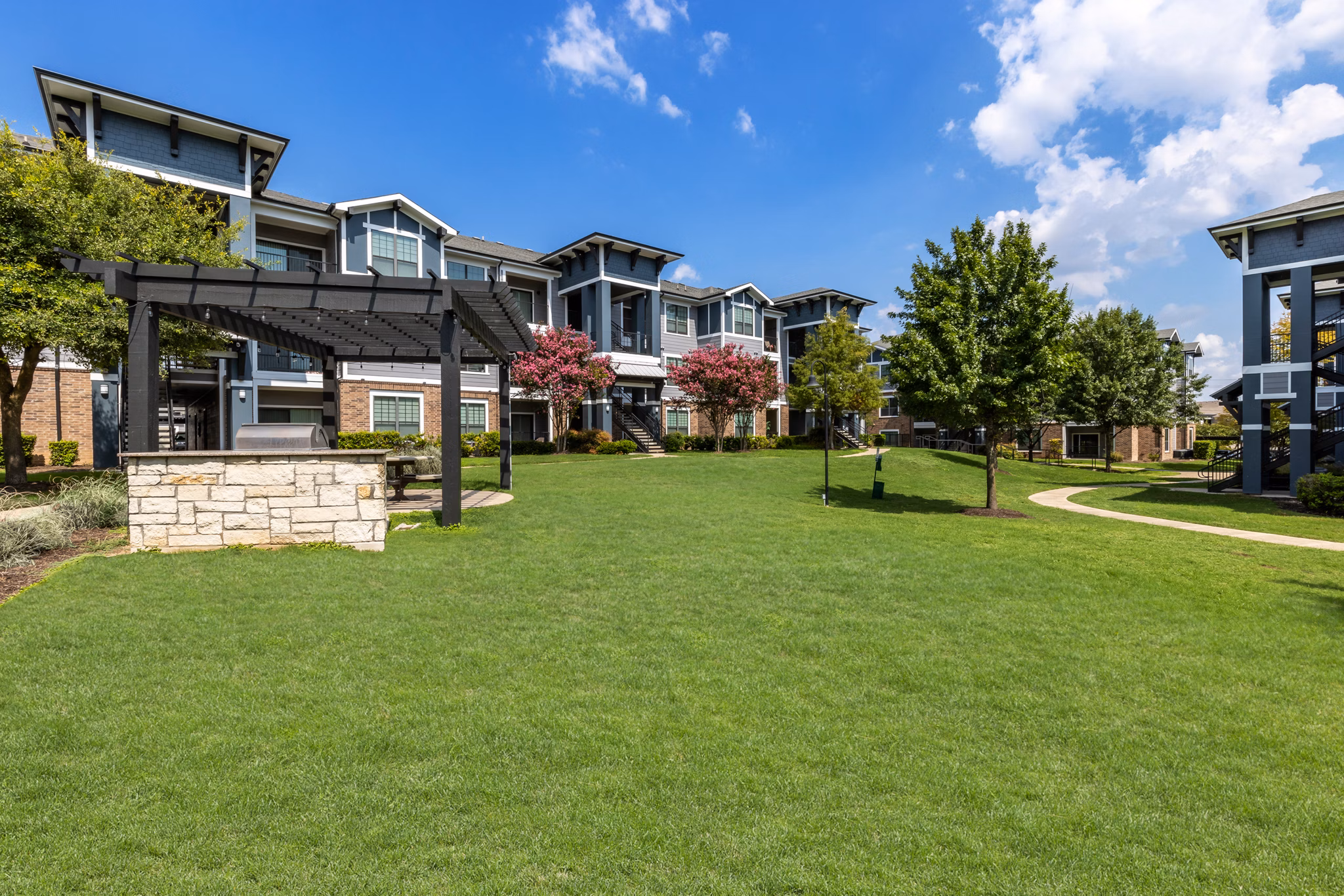 Inviting courtyard featuring modern seating and landscaping at The Oaks at Techridge Apartments