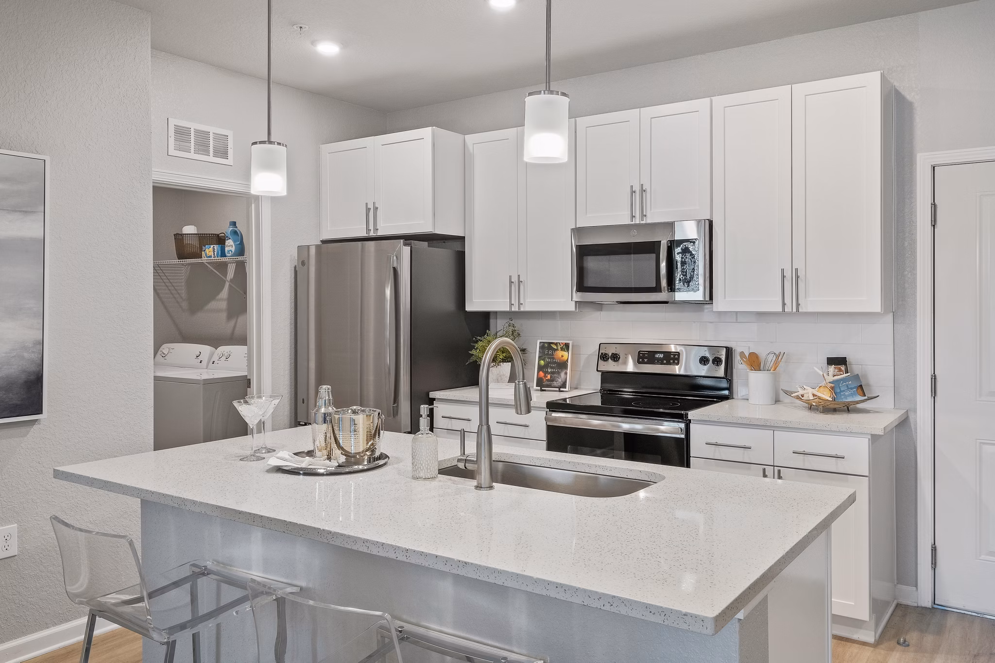 Modern kitchen with granite countertops and stainless steel appliances in Vue at Belleair Apartments
