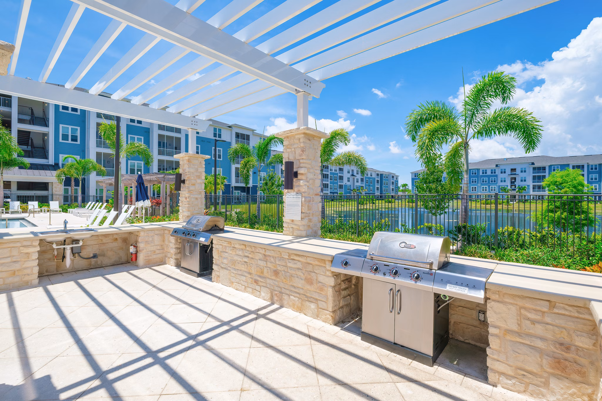 Grill area with seating at Vue at Belleair Apartments, offering outdoor cooking and dining options for residents