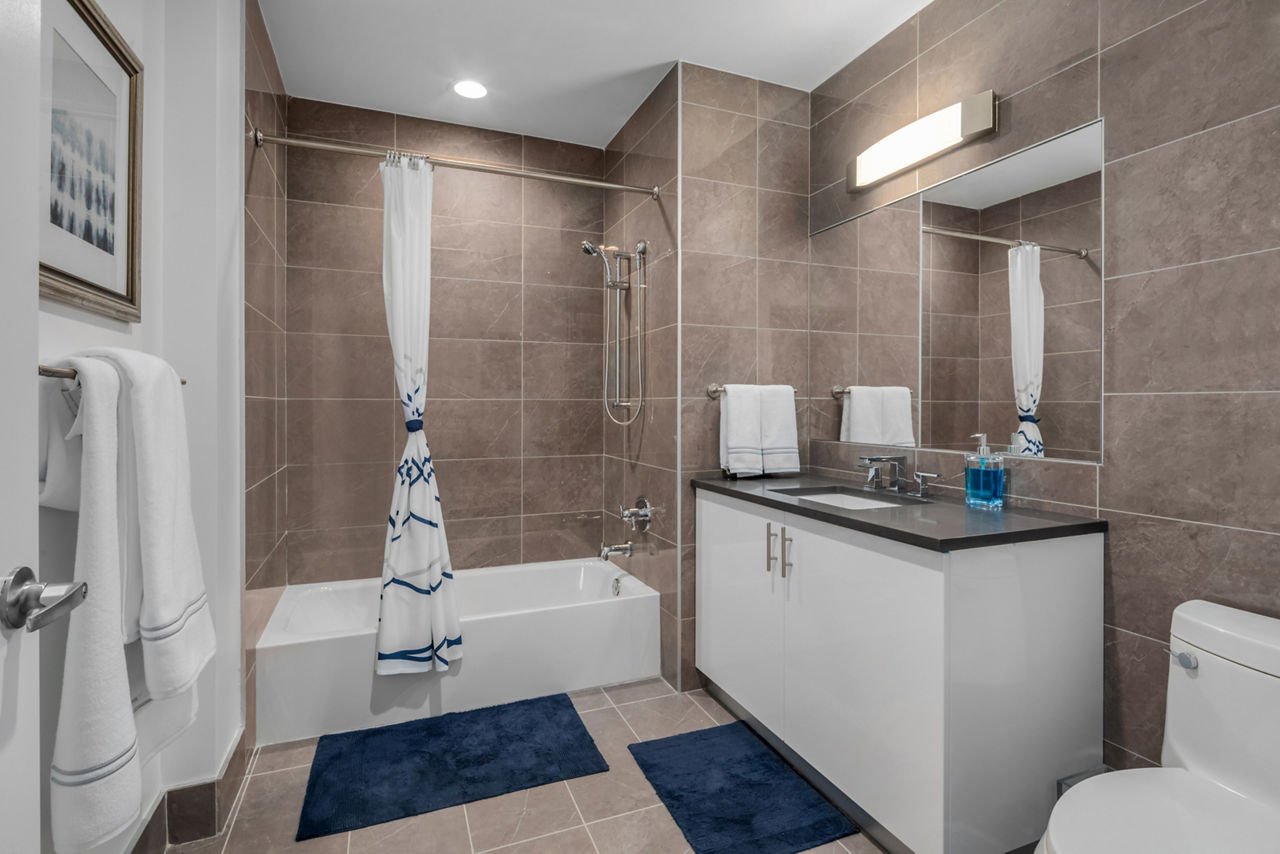 Bathroom featuring modern fixtures and marble countertops in 360 Huguenot Apartments