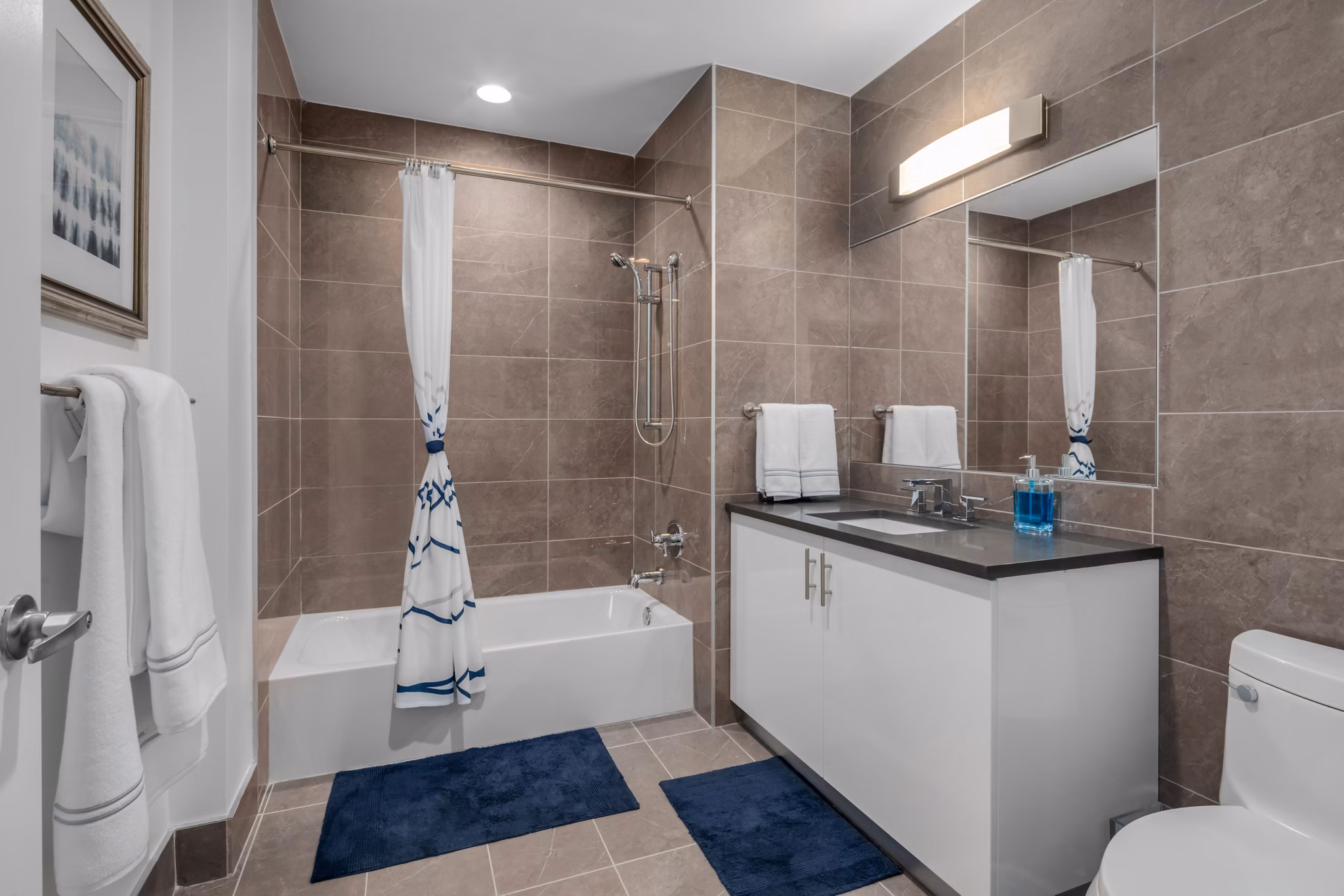 Bathroom featuring modern fixtures and marble countertops in 360 Huguenot Apartments
