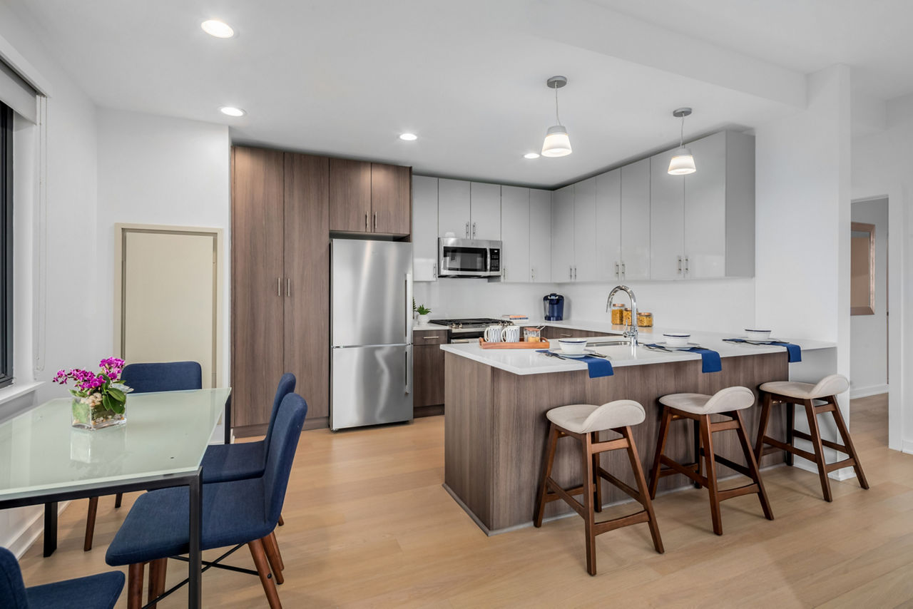 Modern kitchen with stainless steel appliances and sleek countertops at 360 Huguenot Apartments luxury living