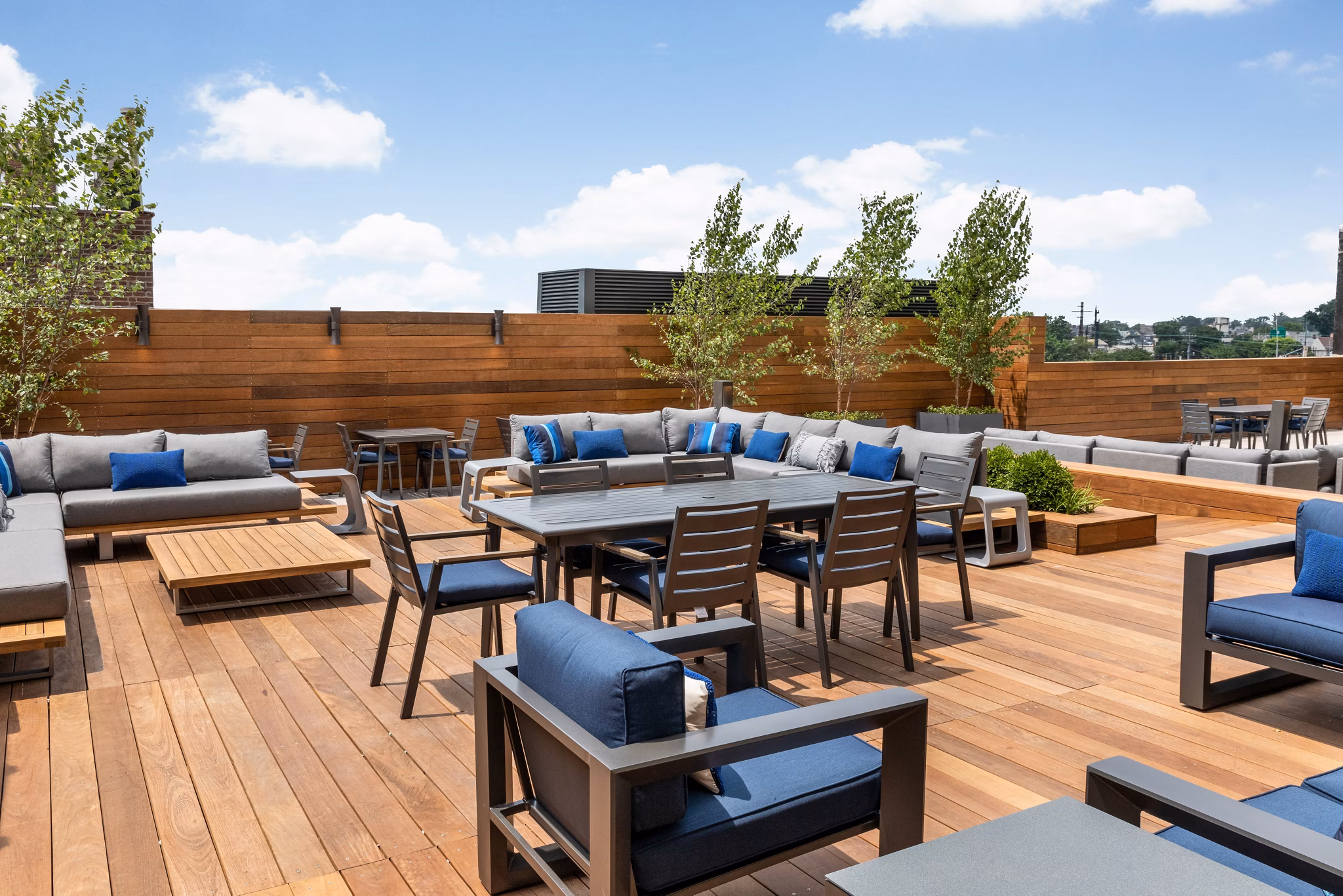 Stylish rooftop deck with seating and garden views at 360 Huguenot Apartments