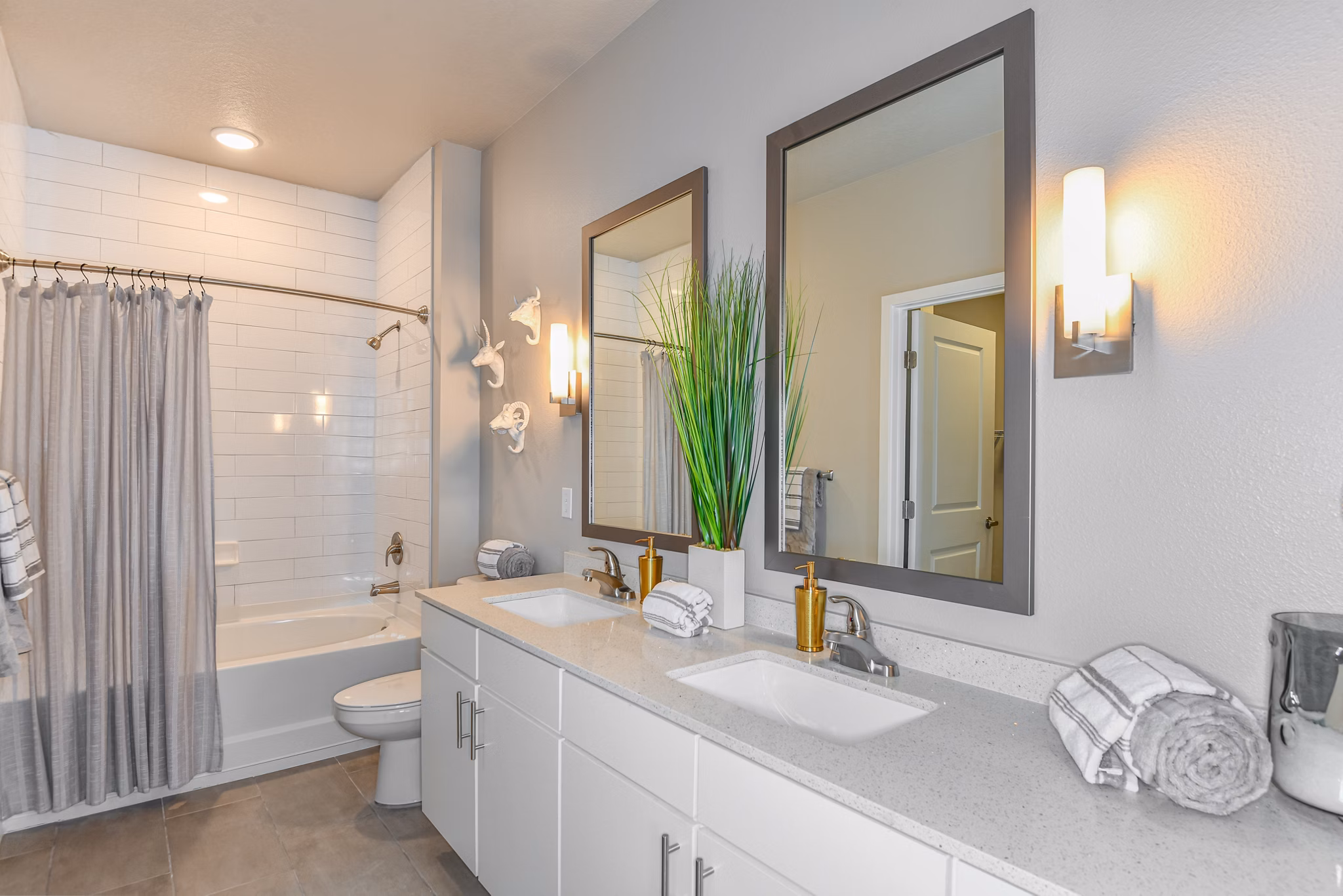 Modern bathroom with sleek fixtures and granite countertops at The Lodge at Hamlin Apartments
