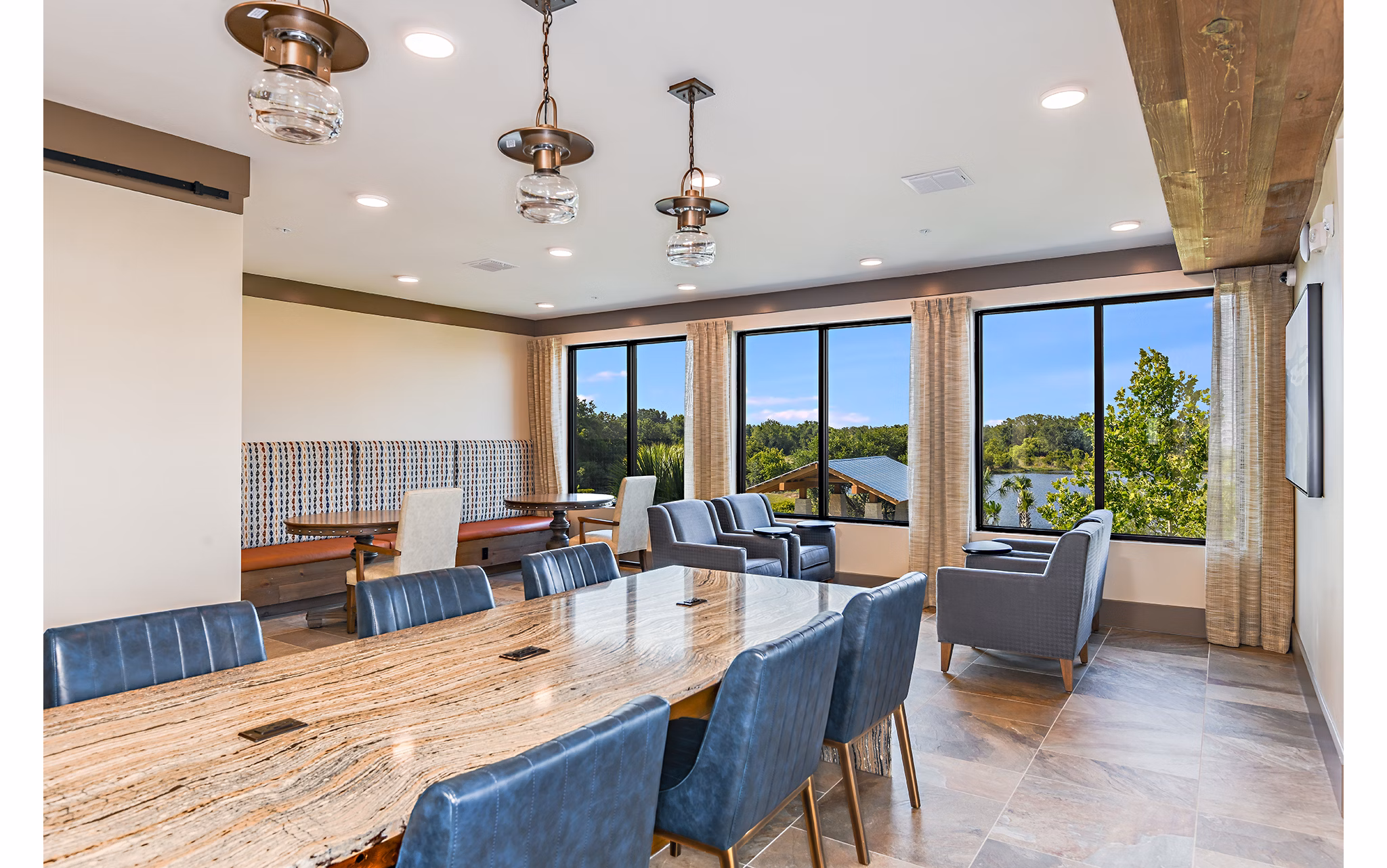 Clubhouse with lounge seating and recreational area at The Lodge at Hamlin Apartments