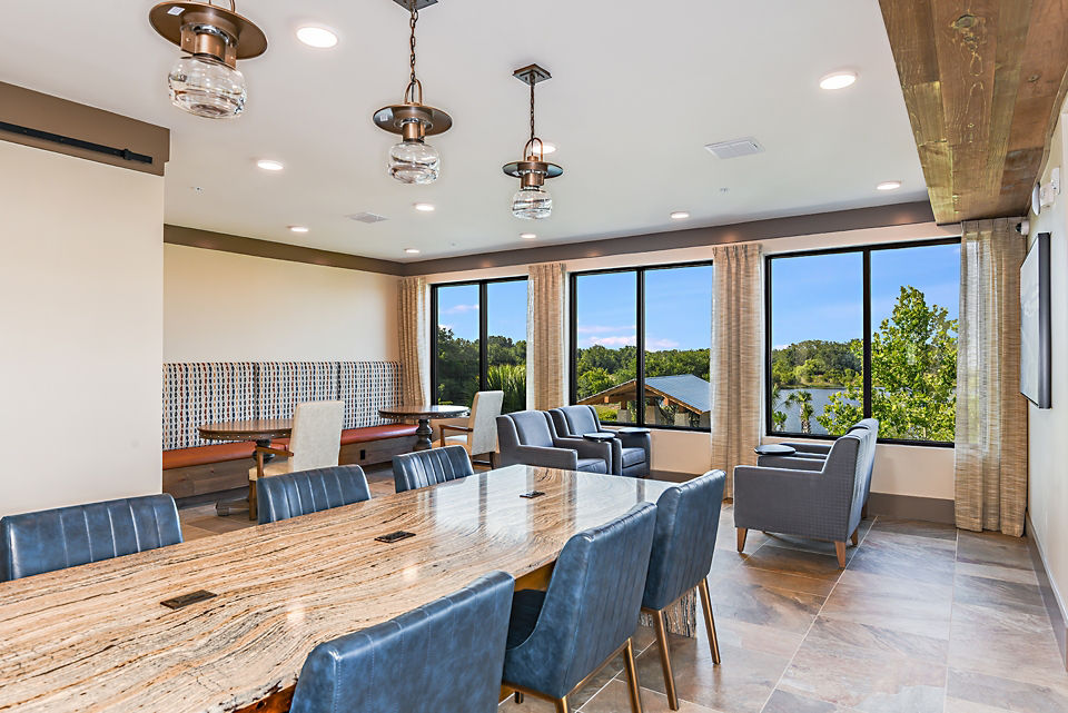 Clubhouse with lounge seating and recreational area at The Lodge at Hamlin Apartments