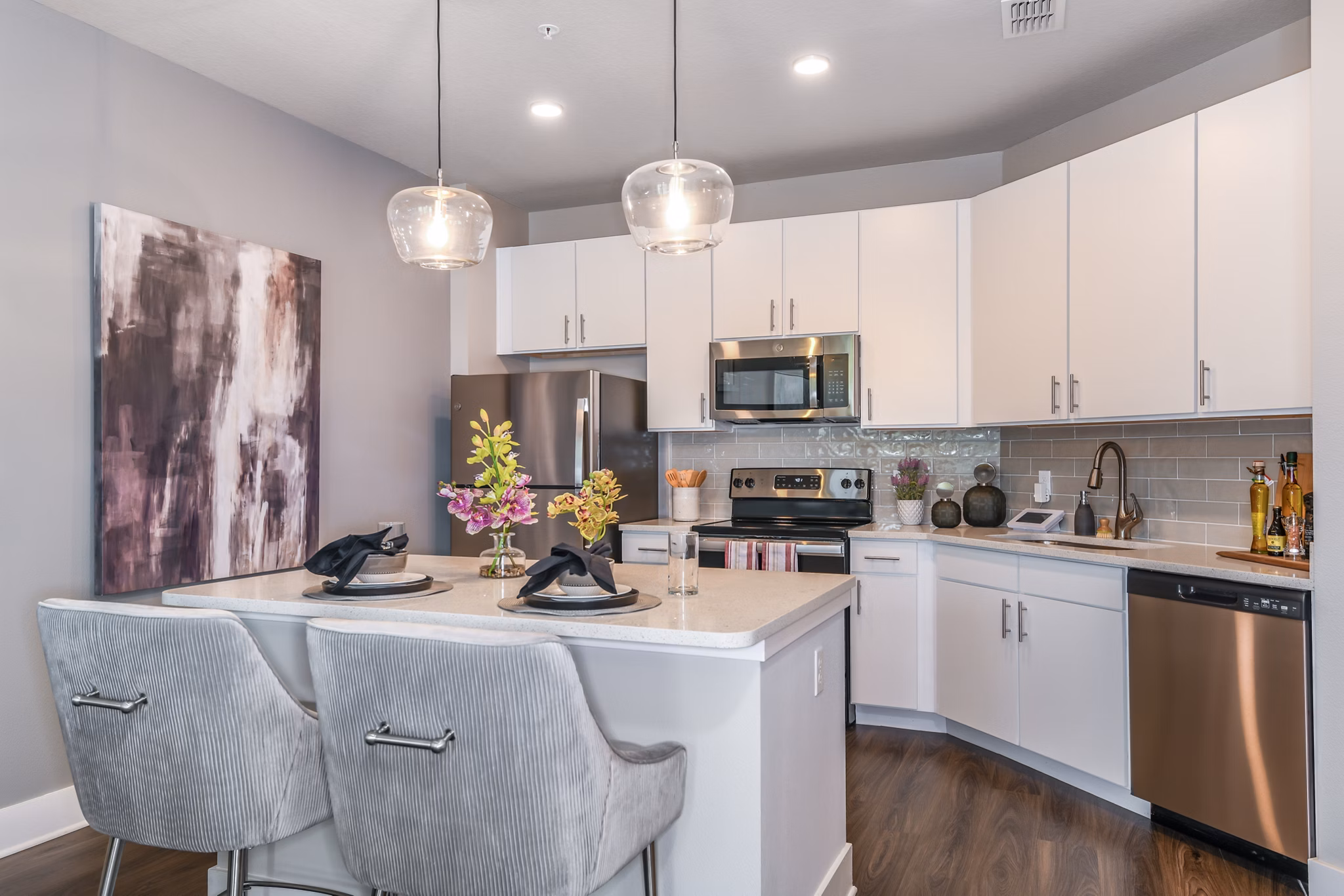 Modern kitchen with stainless steel appliances and granite countertops at The Lodge at Hamlin Apartments