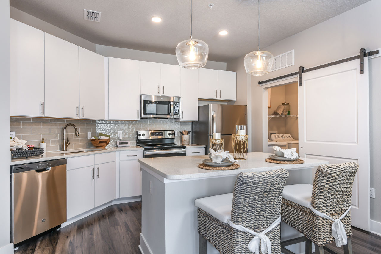 Modern kitchen with stainless steel appliances at The Lodge at Hamlin Apartments
