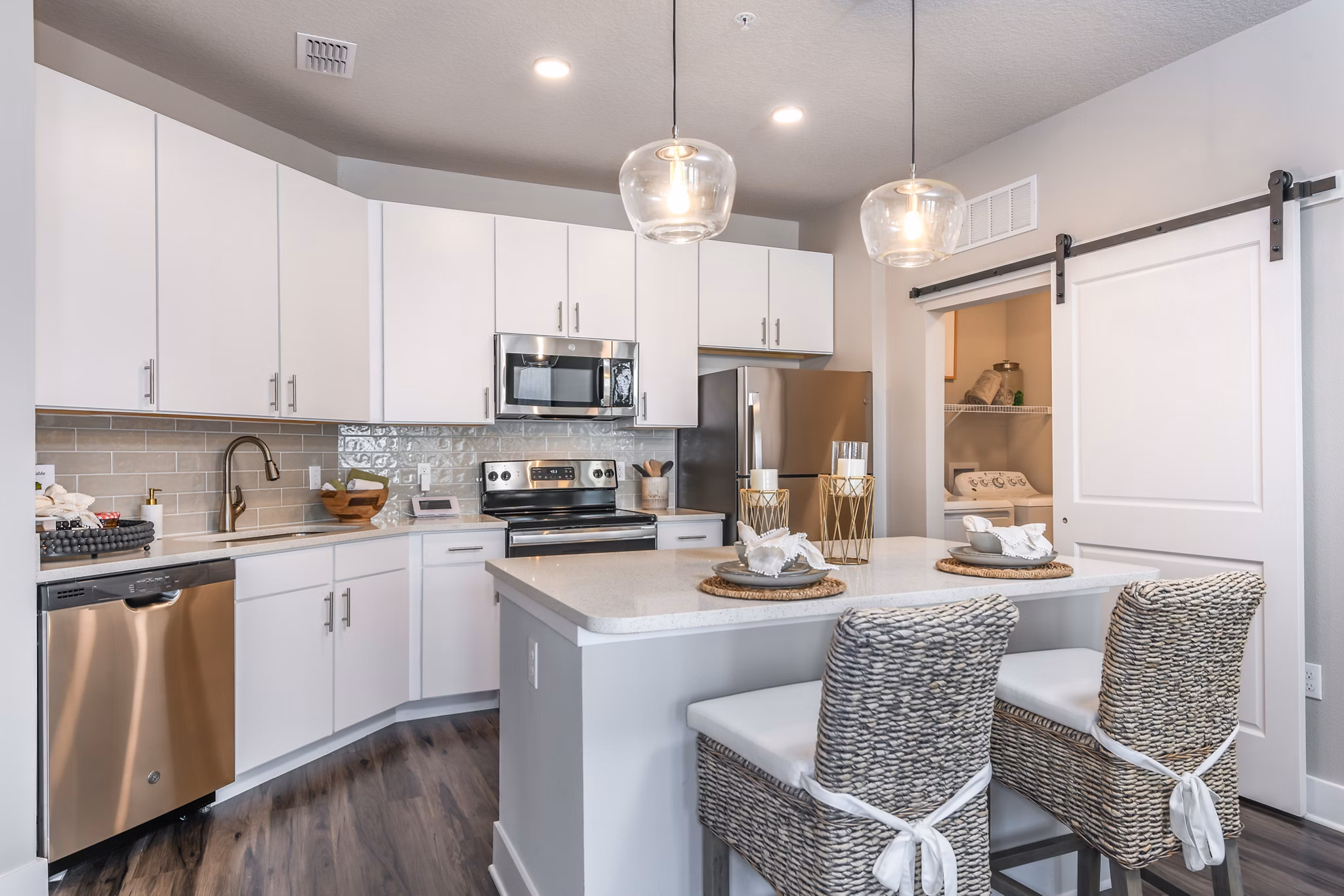 Modern kitchen with stainless steel appliances at The Lodge at Hamlin Apartments