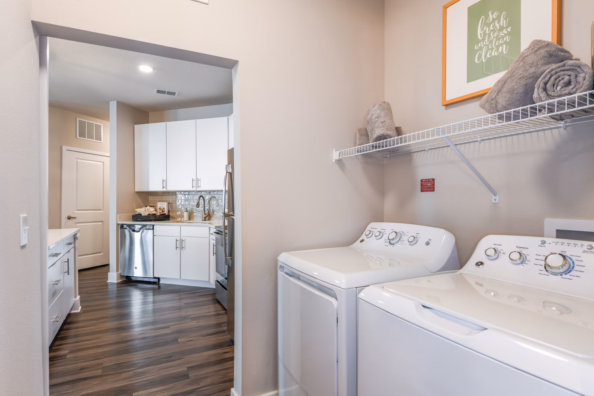 Laundry room with modern appliances at The Lodge at Hamlin Apartments, luxury living by Greystar