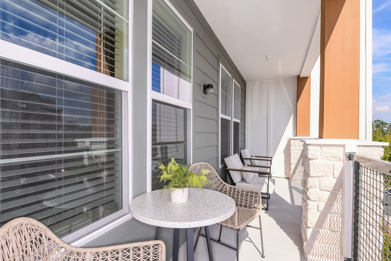 The Lodge at Hamlin: Stylish patio with seating and firepit at luxury apartments in scenic Greystar community