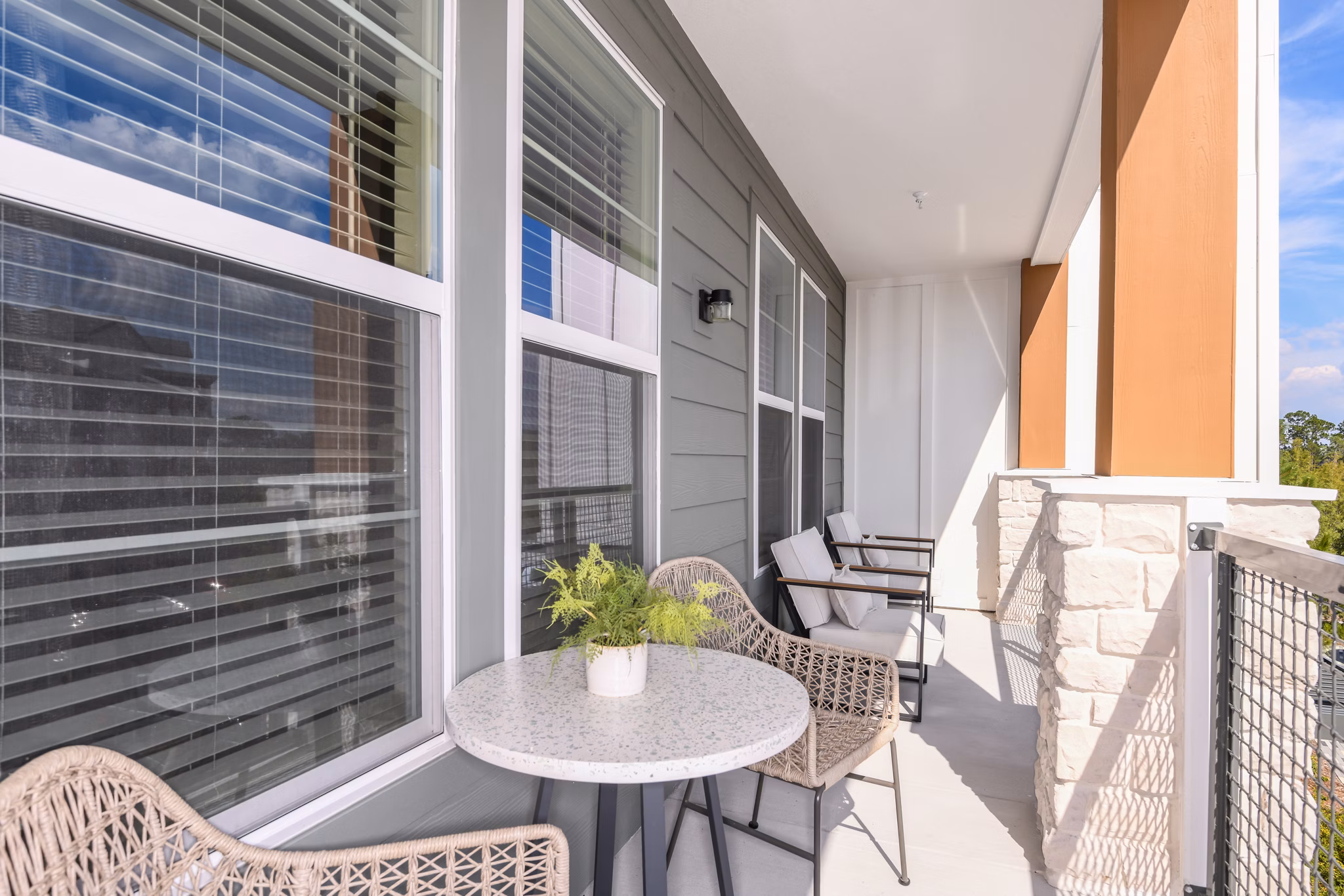 The Lodge at Hamlin: Stylish patio with seating and firepit at luxury apartments in scenic Greystar community