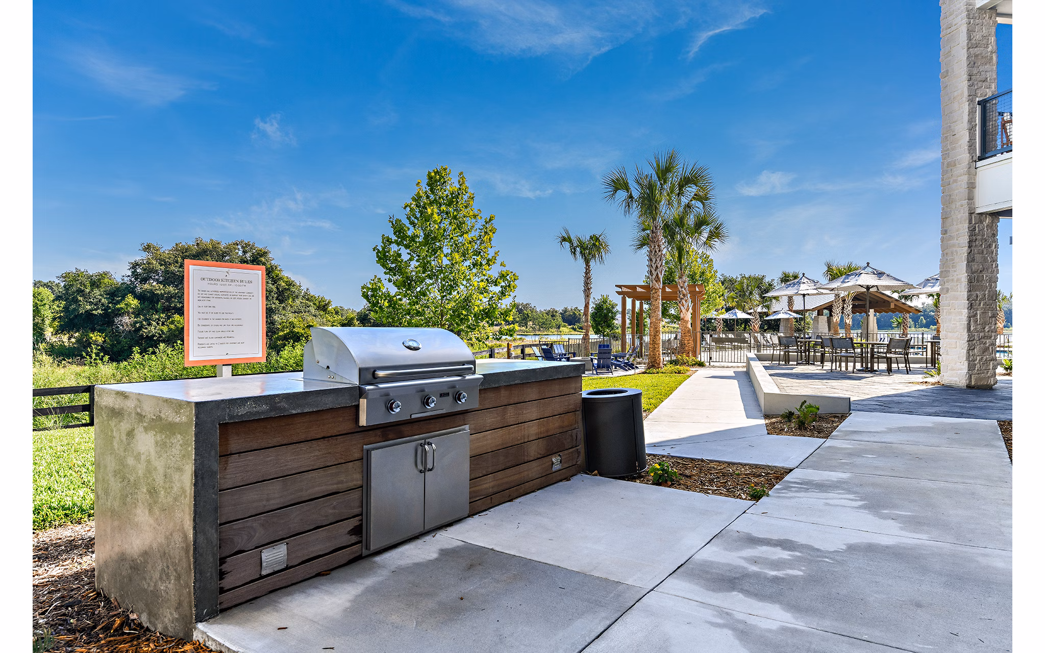 Grill area with outdoor seating at The Lodge at Hamlin Apartments