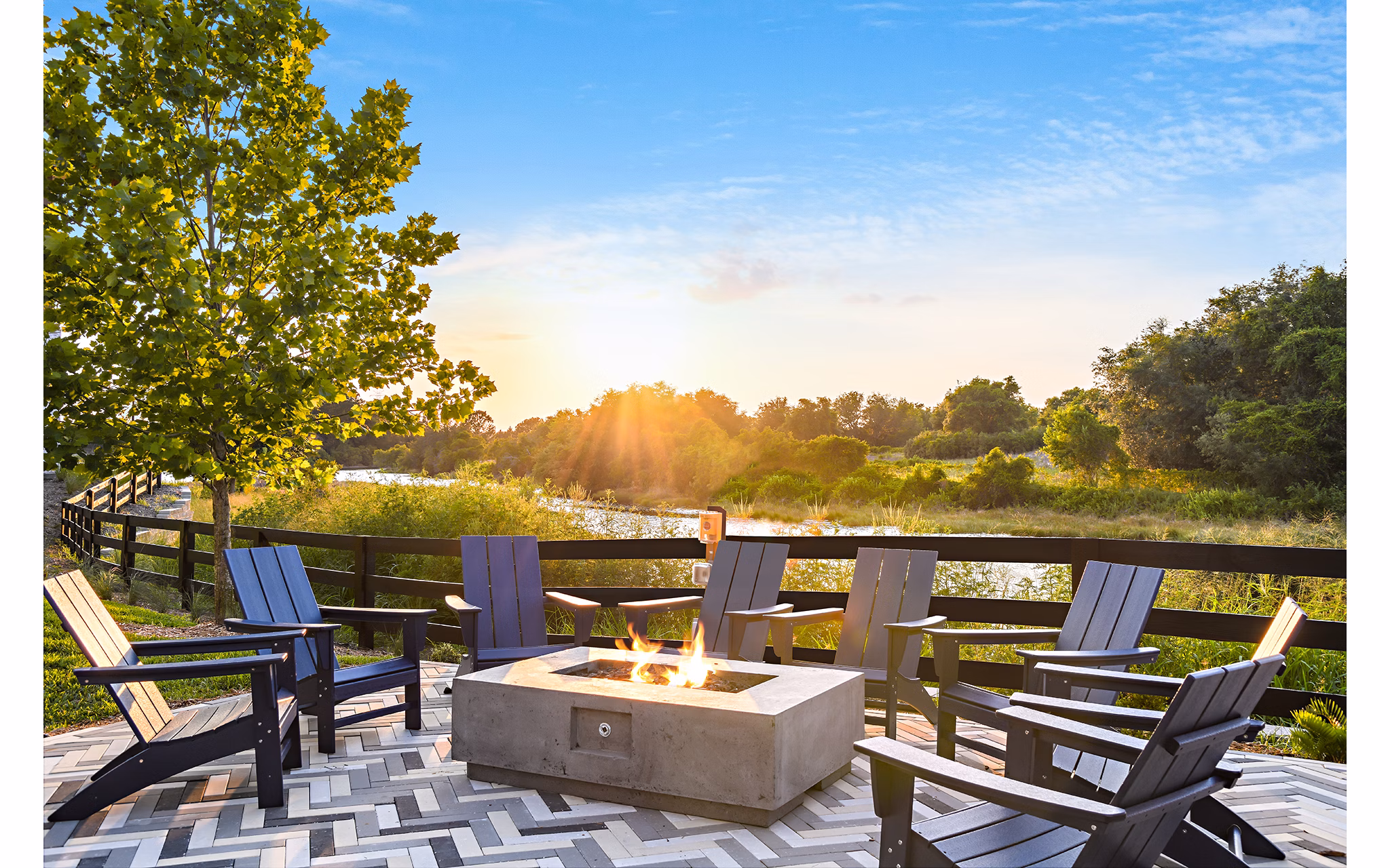 Outdoor fire pit area at The Lodge at Hamlin Apartments with cozy seating and string lights Perfect for relaxing and entertaining