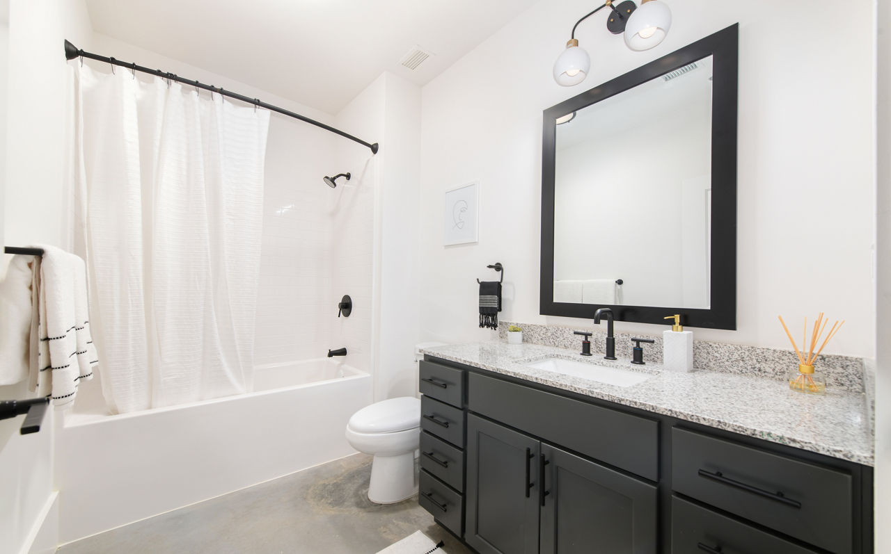 Modern bathroom with elegant fixtures in The Lofts at Woodside Mill Apartments
