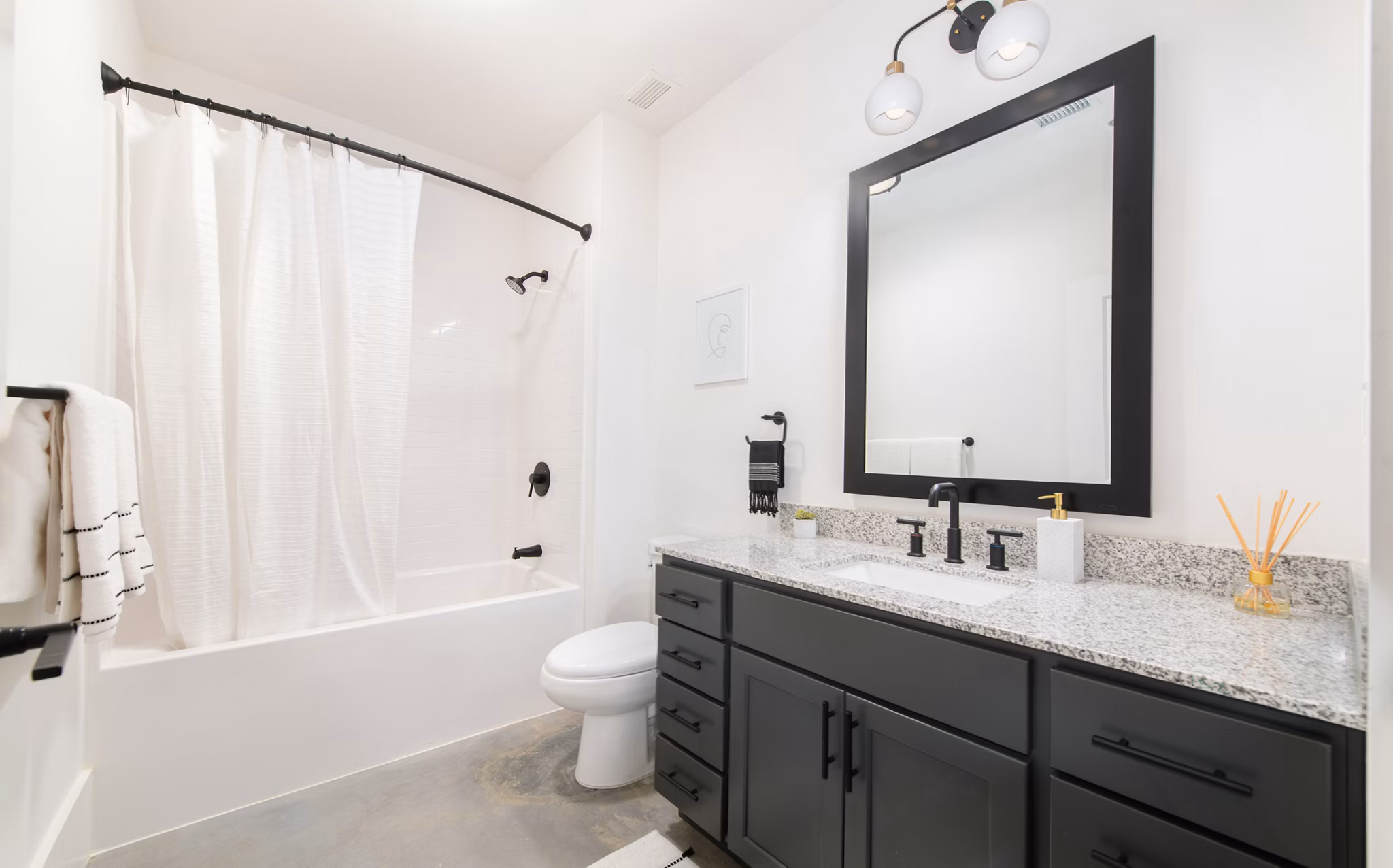 Modern bathroom with elegant fixtures in The Lofts at Woodside Mill Apartments
