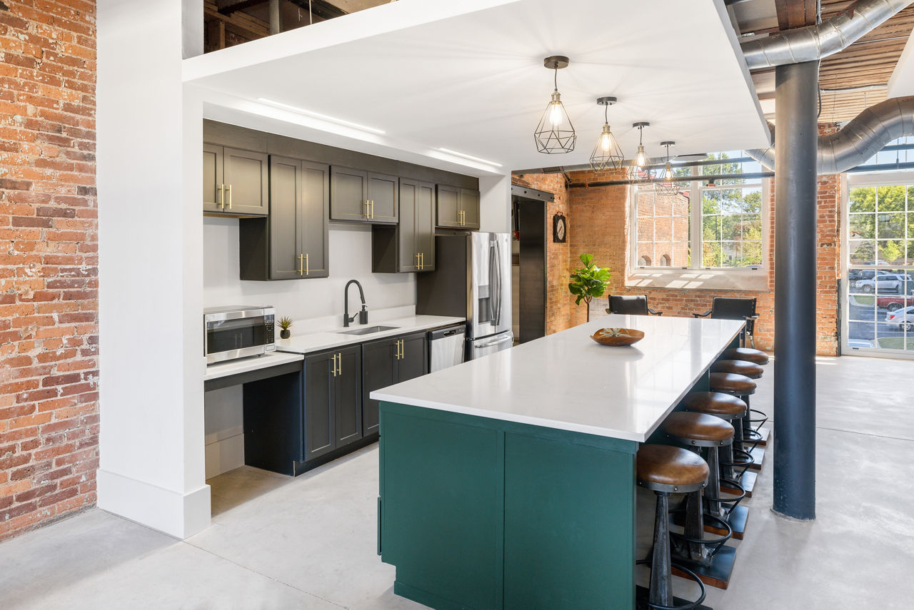 Clubhouse featuring modern design and comfortable seating at The Lofts at Woodside Mill Apartments