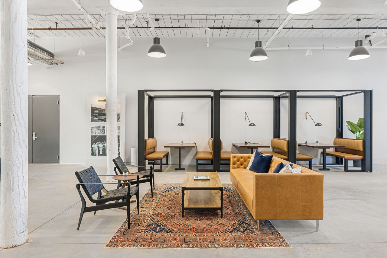 Chic clubhouse at The Lofts at Woodside Mill Apartments with plush seating and modern design