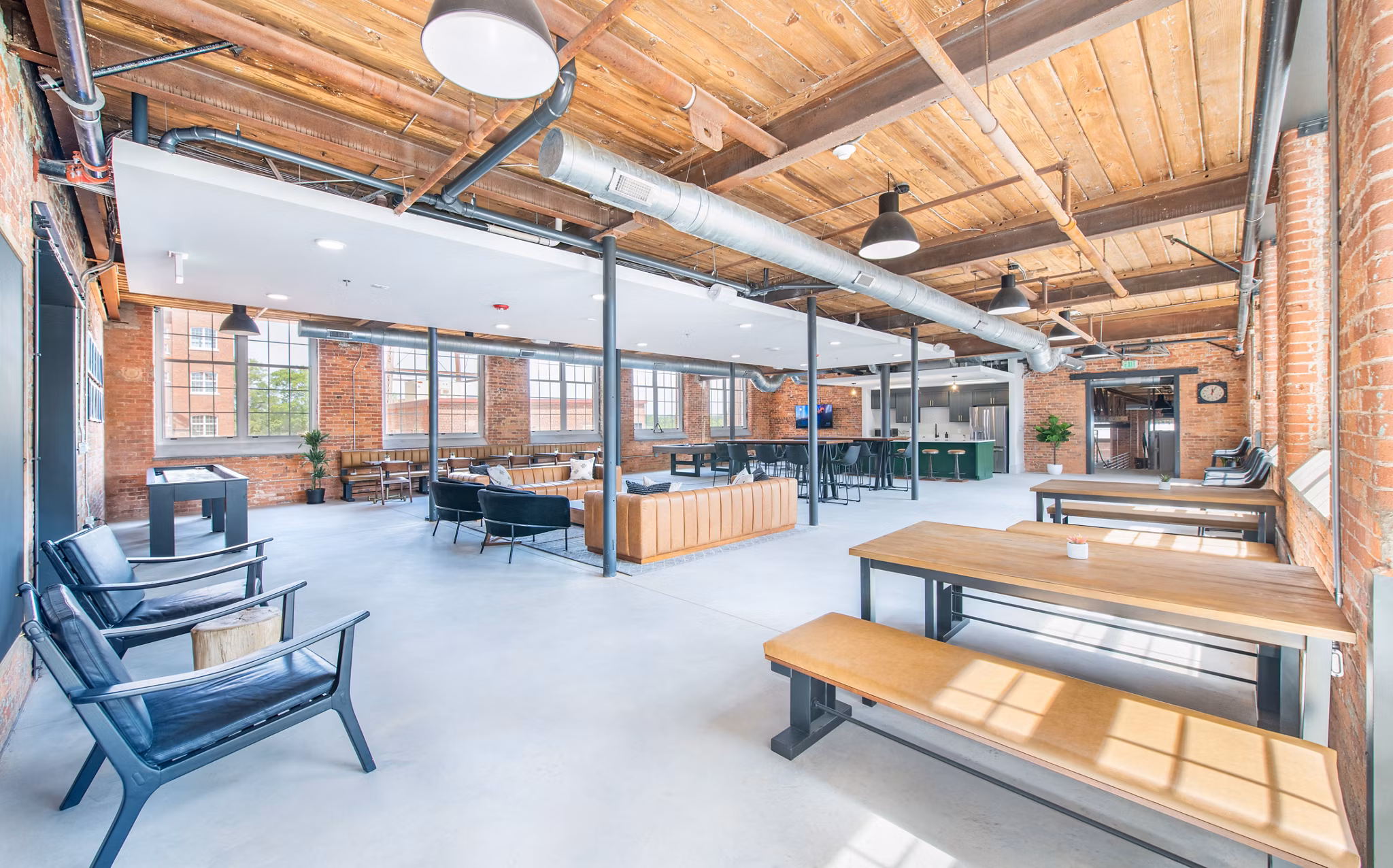 Clubhouse featuring sleek design and modern furnishings at The Lofts at Woodside Mill Apartments