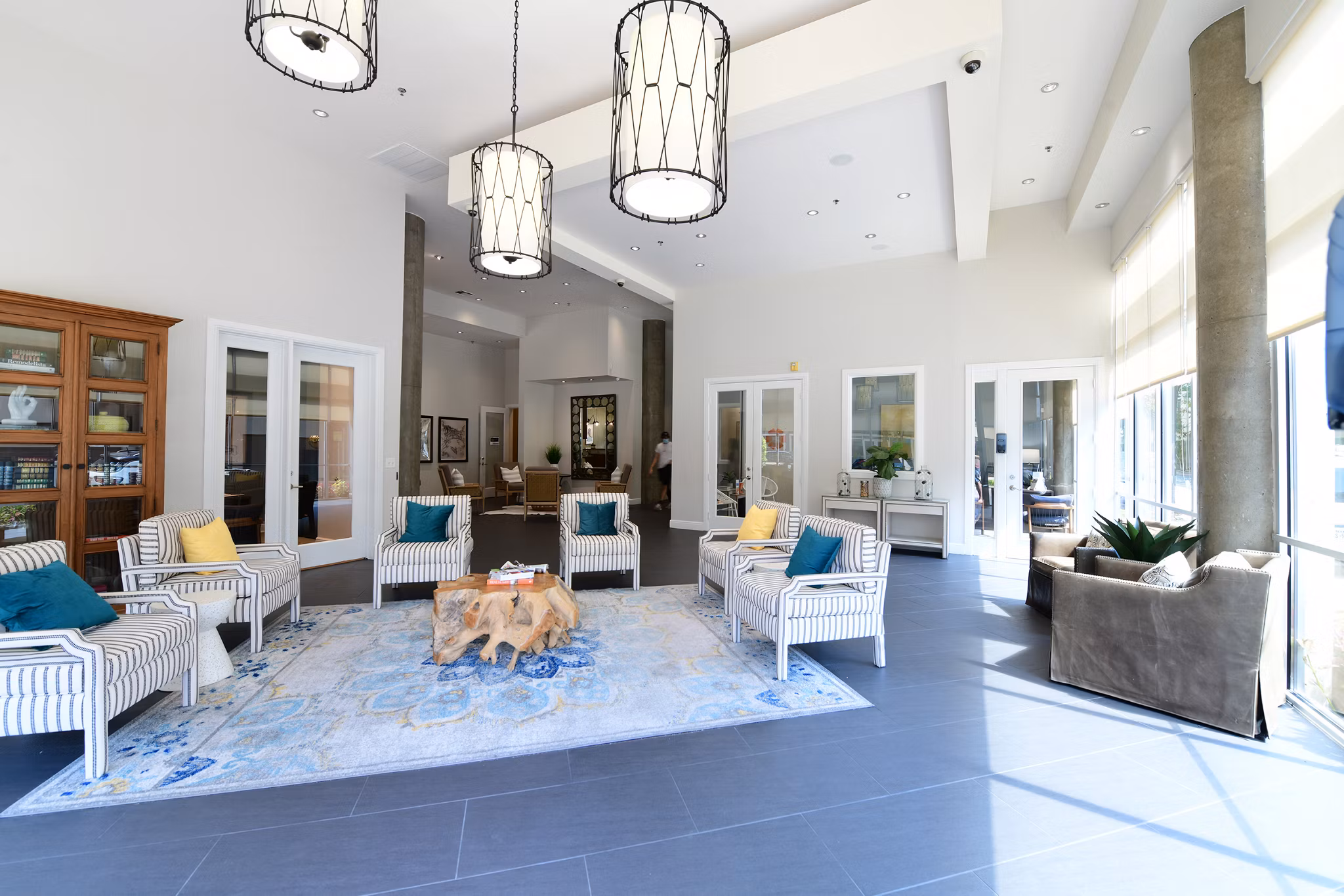 Modern clubhouse at The Lofts at Woodside Mill Apartments featuring cozy seating and large windows