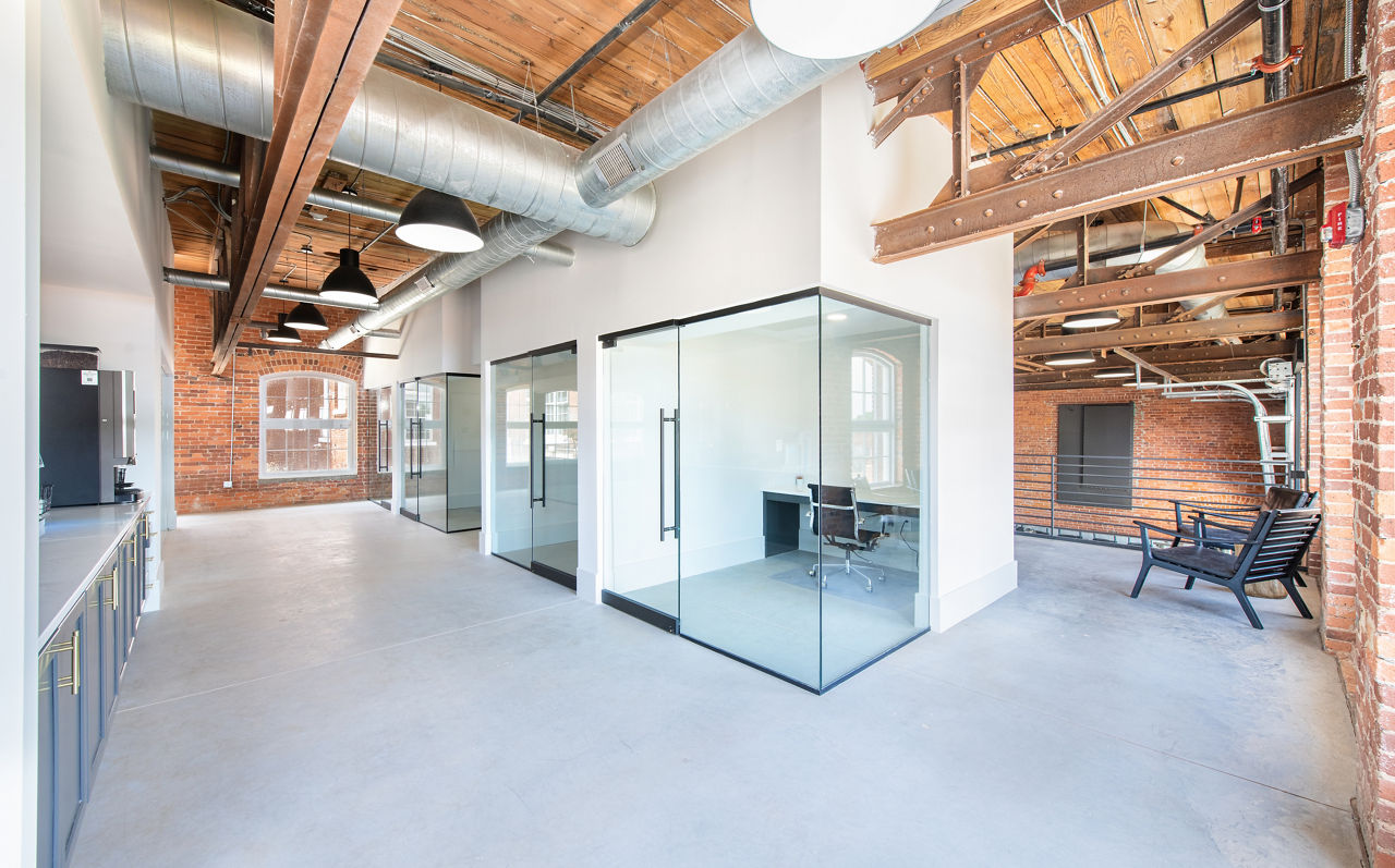 Clubhouse with modern seating and open space at The Lofts at Woodside Mill Apartments