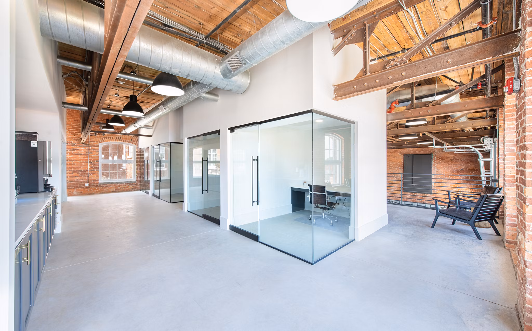 Clubhouse with modern seating and open space at The Lofts at Woodside Mill Apartments