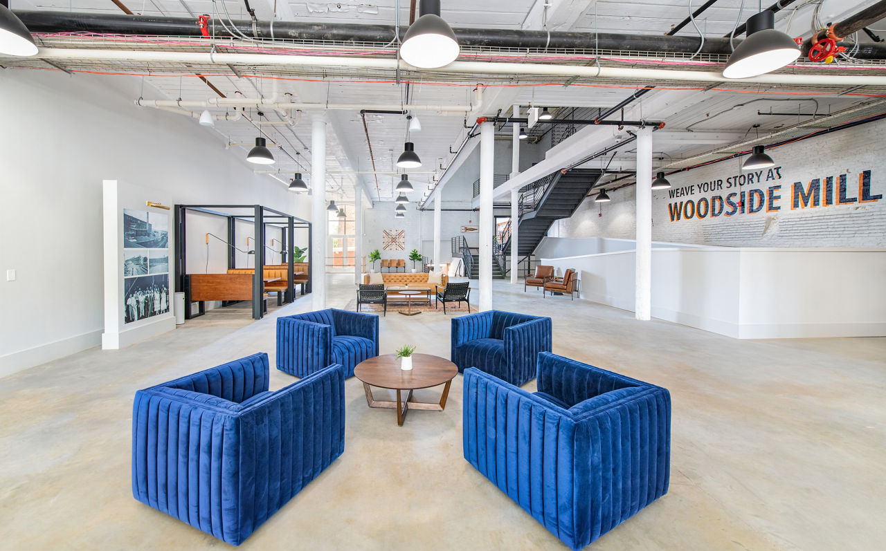 Clubhouse with cozy seating areas at The Lofts at Woodside Mill Apartments