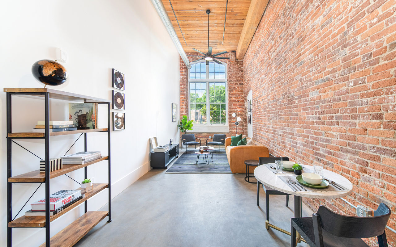 Dining area featuring modern furniture and industrial design at The Lofts at Woodside Mill Apartments